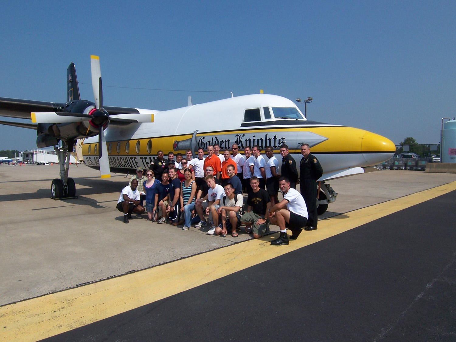 the Golden Knights pose with UVA students