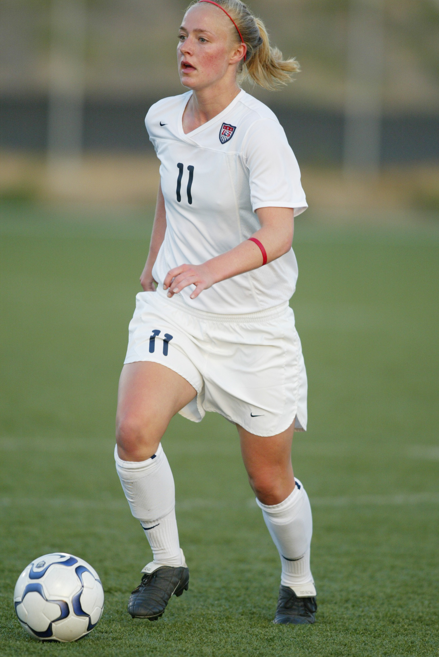 Becky Sauerbrunn running on a soccer field during a game