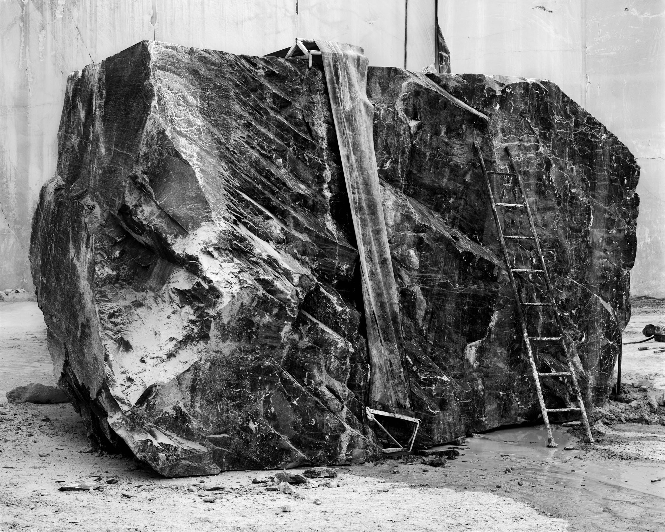 Big boulder with a ladder leaning against it