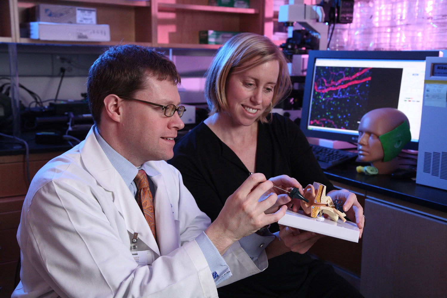 Dr. Bradley Kesser, left, and Shayn Peirce-Cottler, right, working together with a 3d diagram