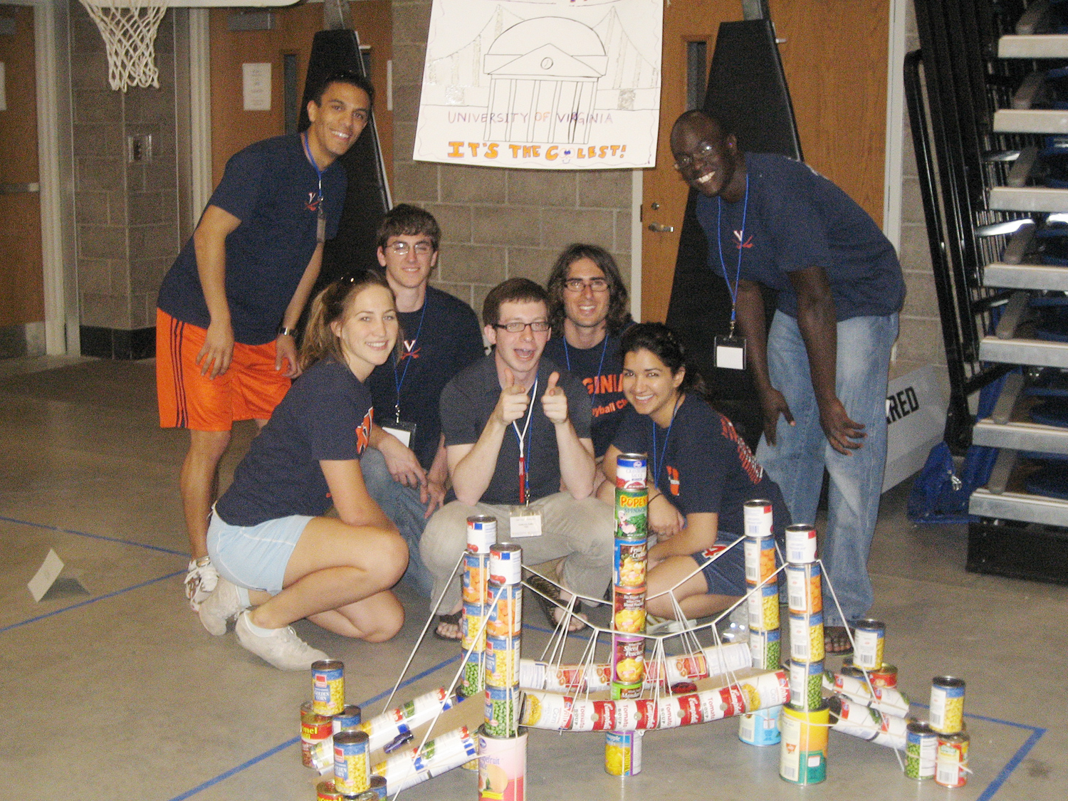 UVA engineering students stand behind their bridge made from canned food