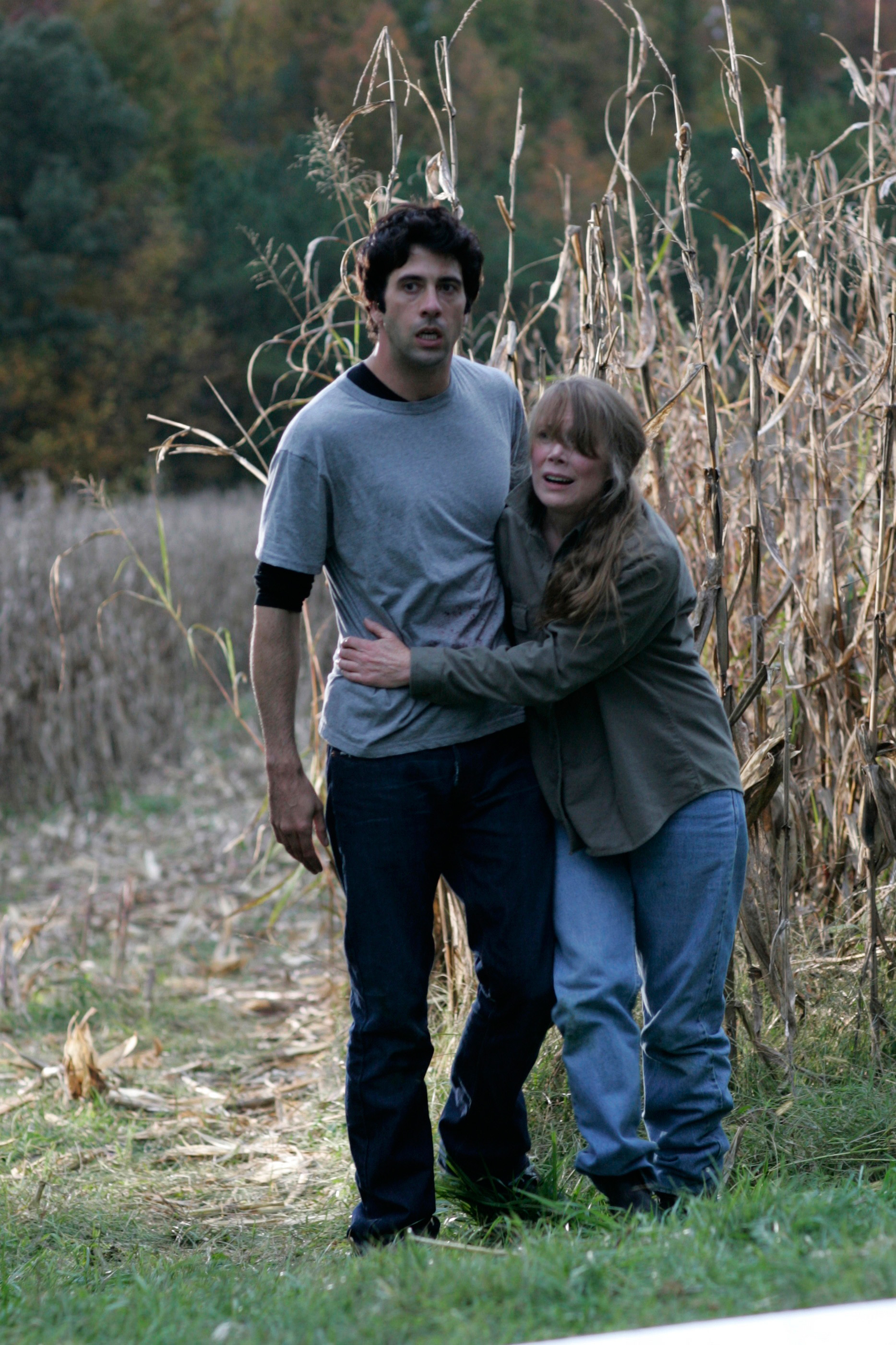 Troy Garity and Sissy Spacek walking through a field on a movie set