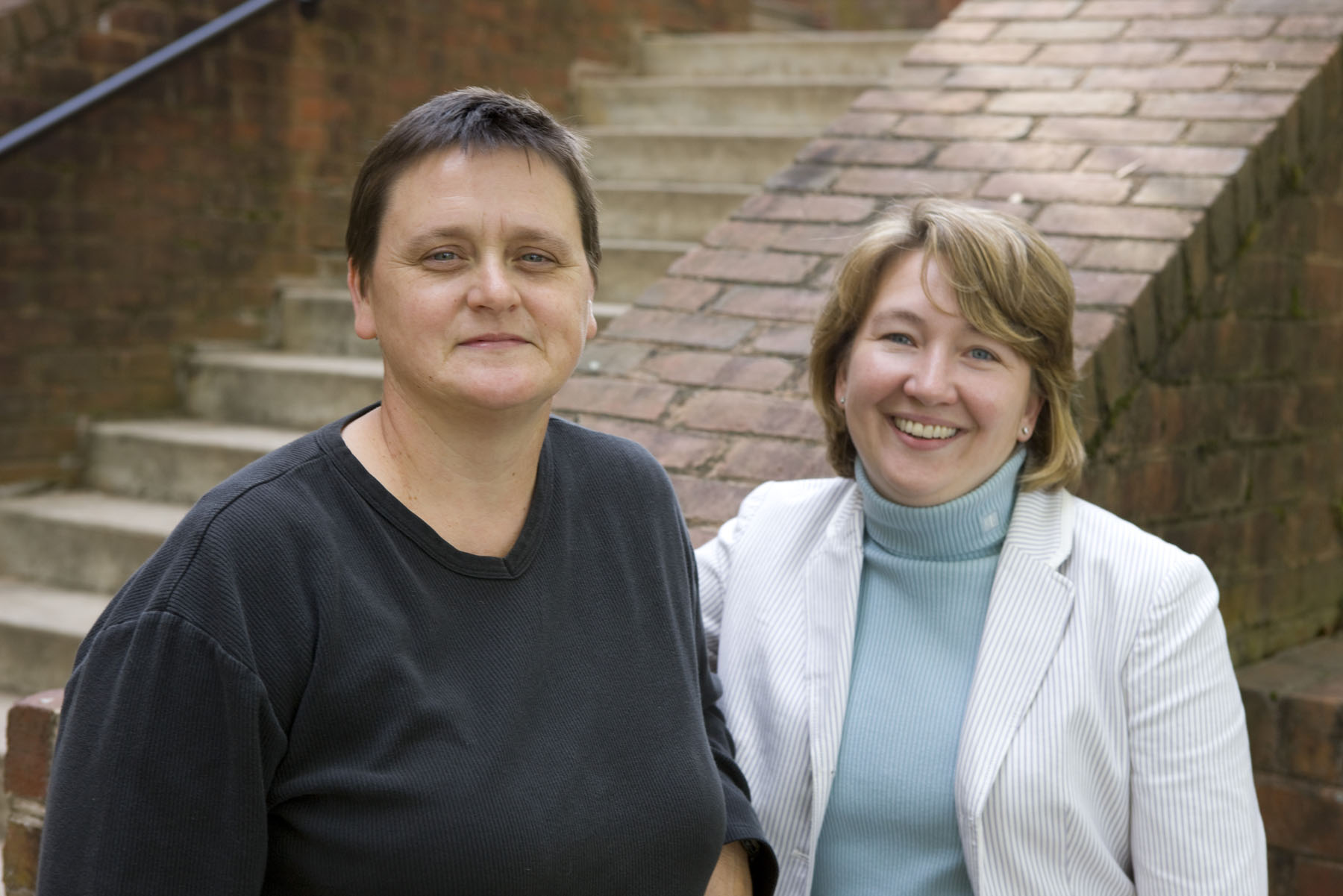 Tonya Moon (left) and Catherine Brighton (right) stand next to each other smiling at the camera 