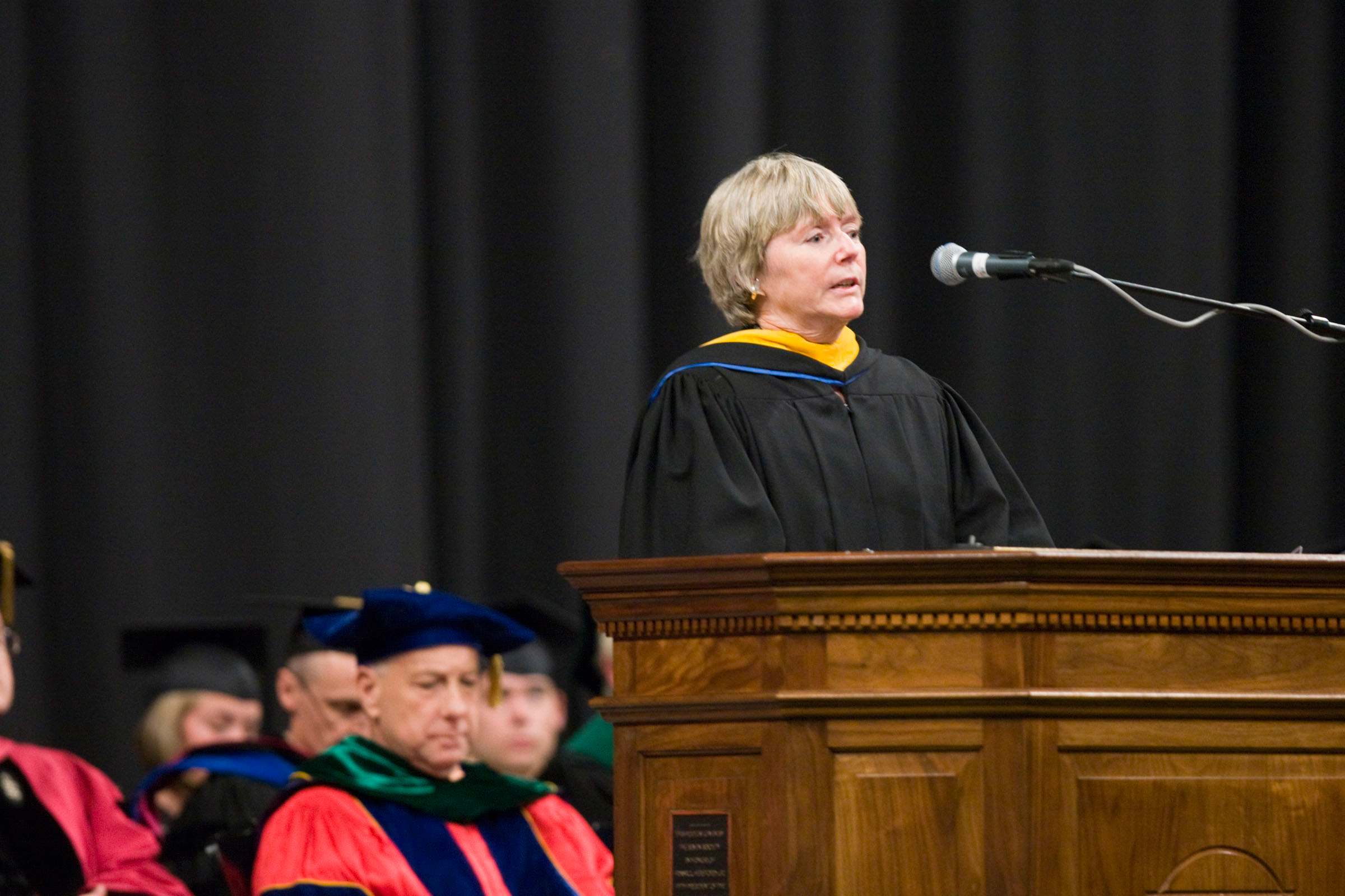 Karin Wittenborg speaking at a podium during graduation