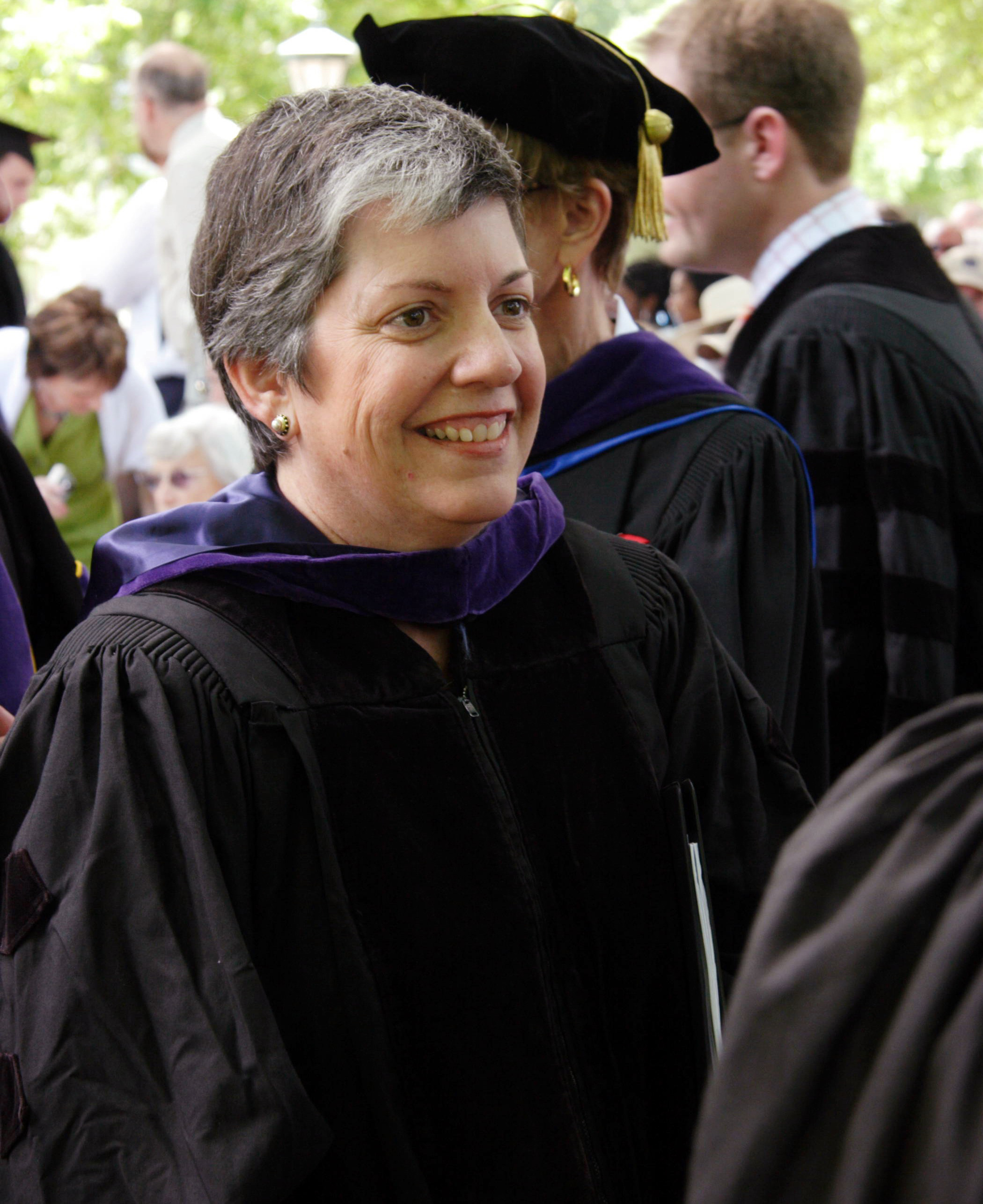 Janet Napolitano walking in cap and gown