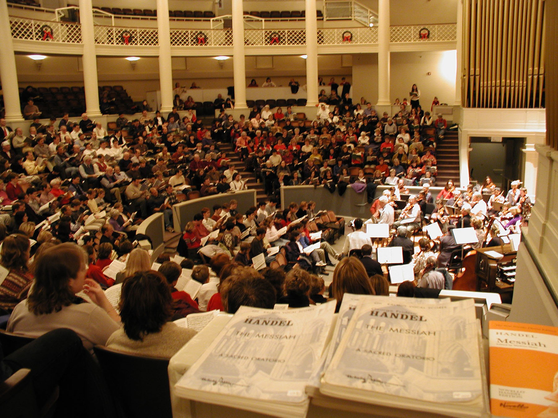 Musicians and singers gather in an auditorium to rehearse Handel's The Messiah