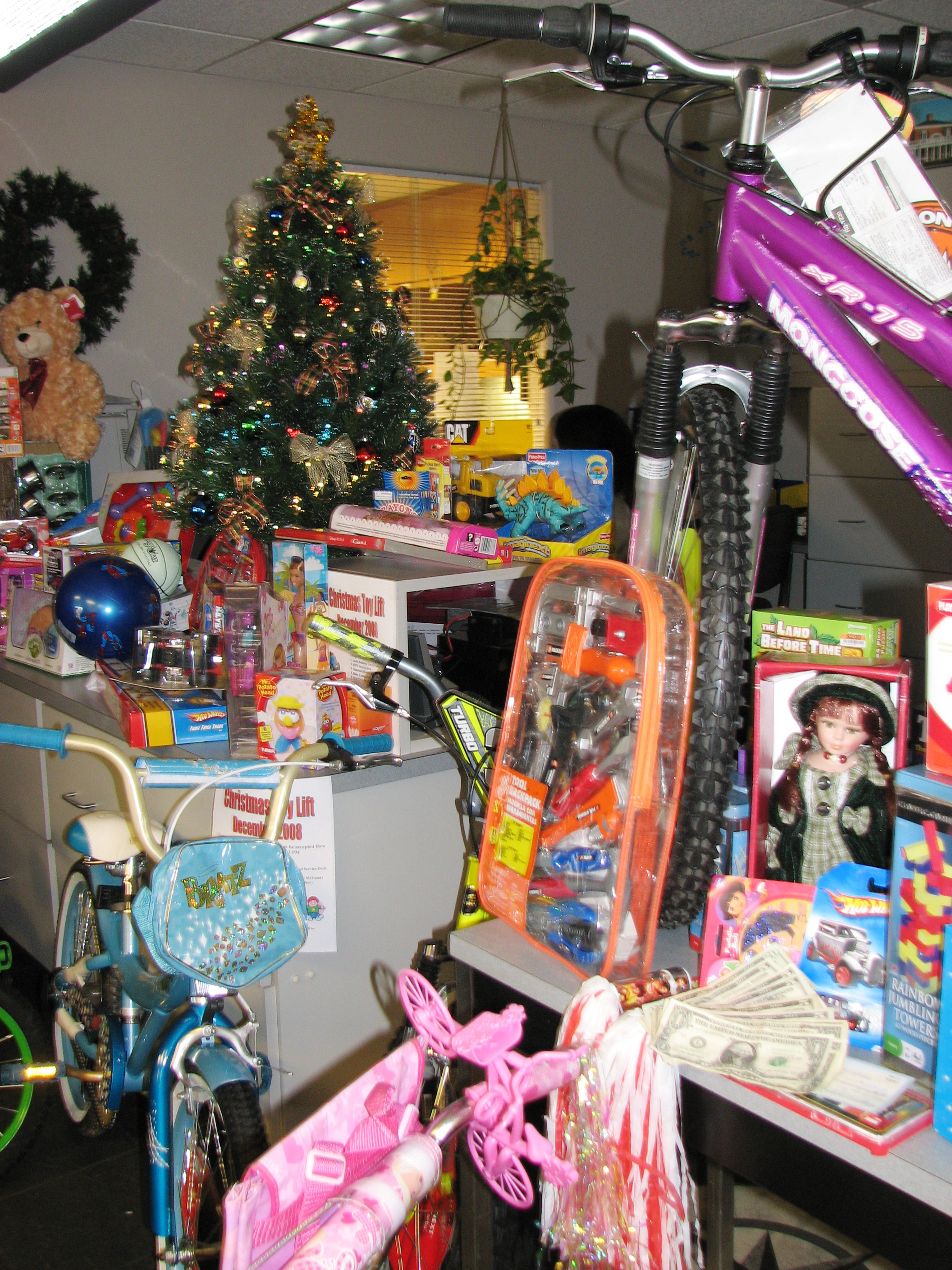 Toy donations in a pile at a Christmas Tree