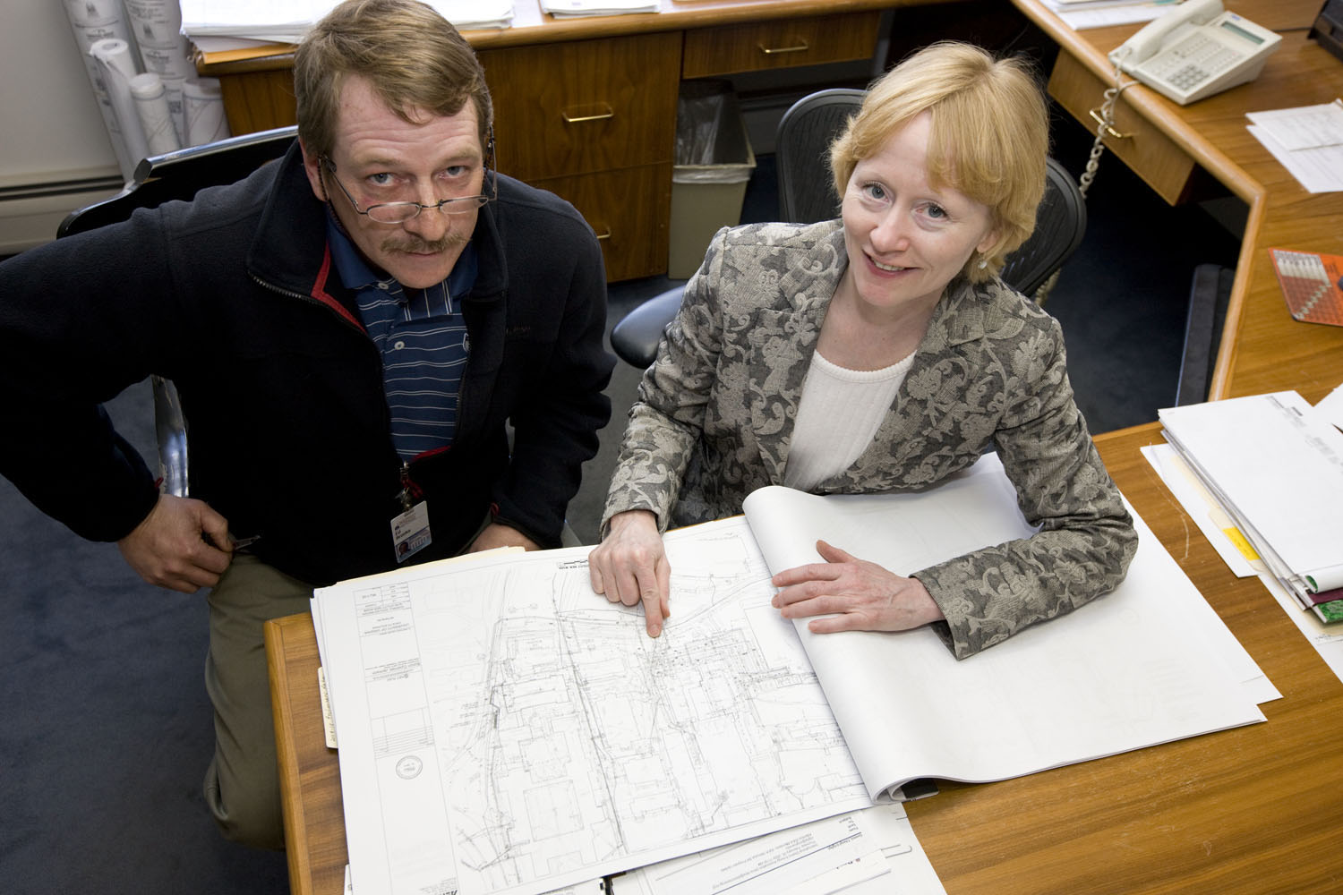 Cheryl Gomez and Ed Brooks looking at architectural drawings together