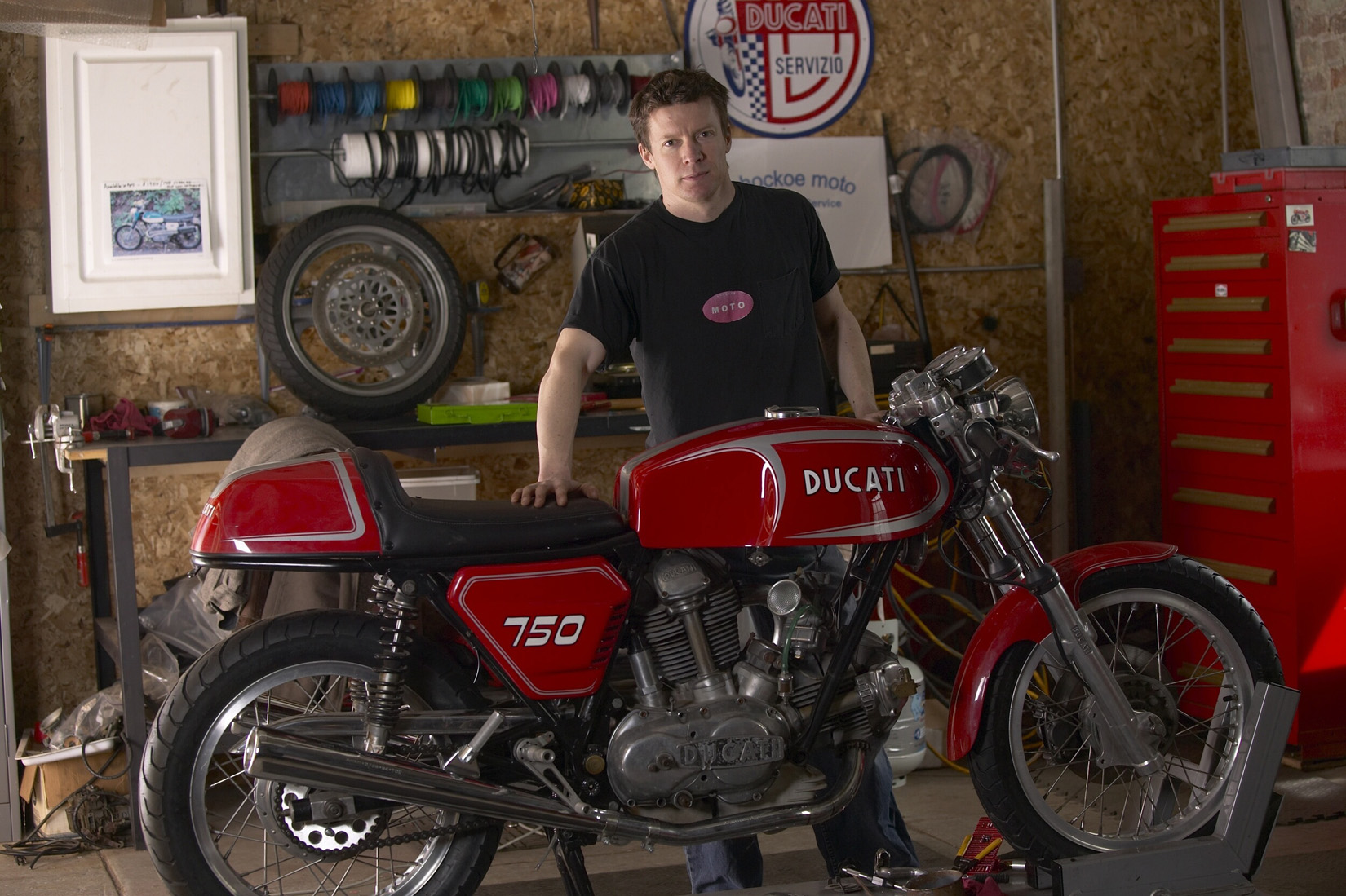 Matthew Crawford stands with a 750 Ducati motorcycle