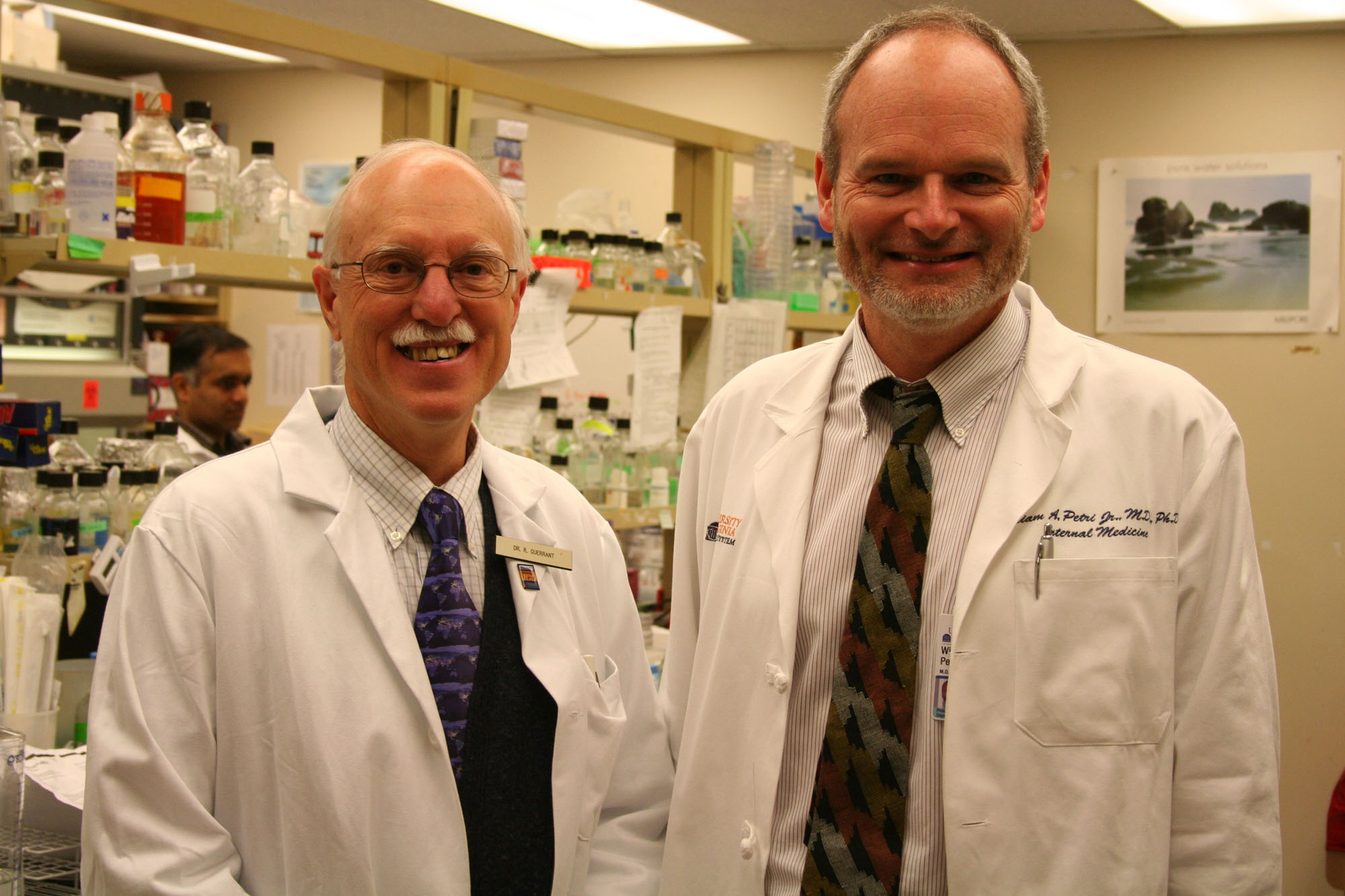 Dr. Richard Guerrant (left) and Dr. William Petri, Jr. stand next to each other smiling at the camere