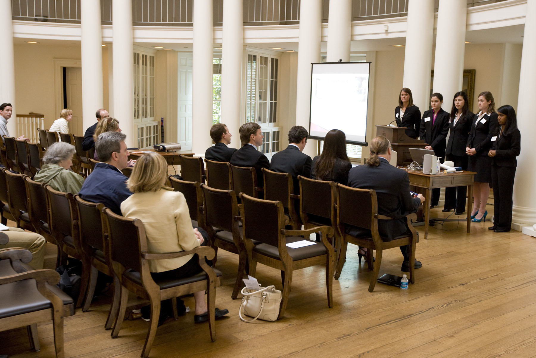 Group of students stand in front of an audience giving a presentation
