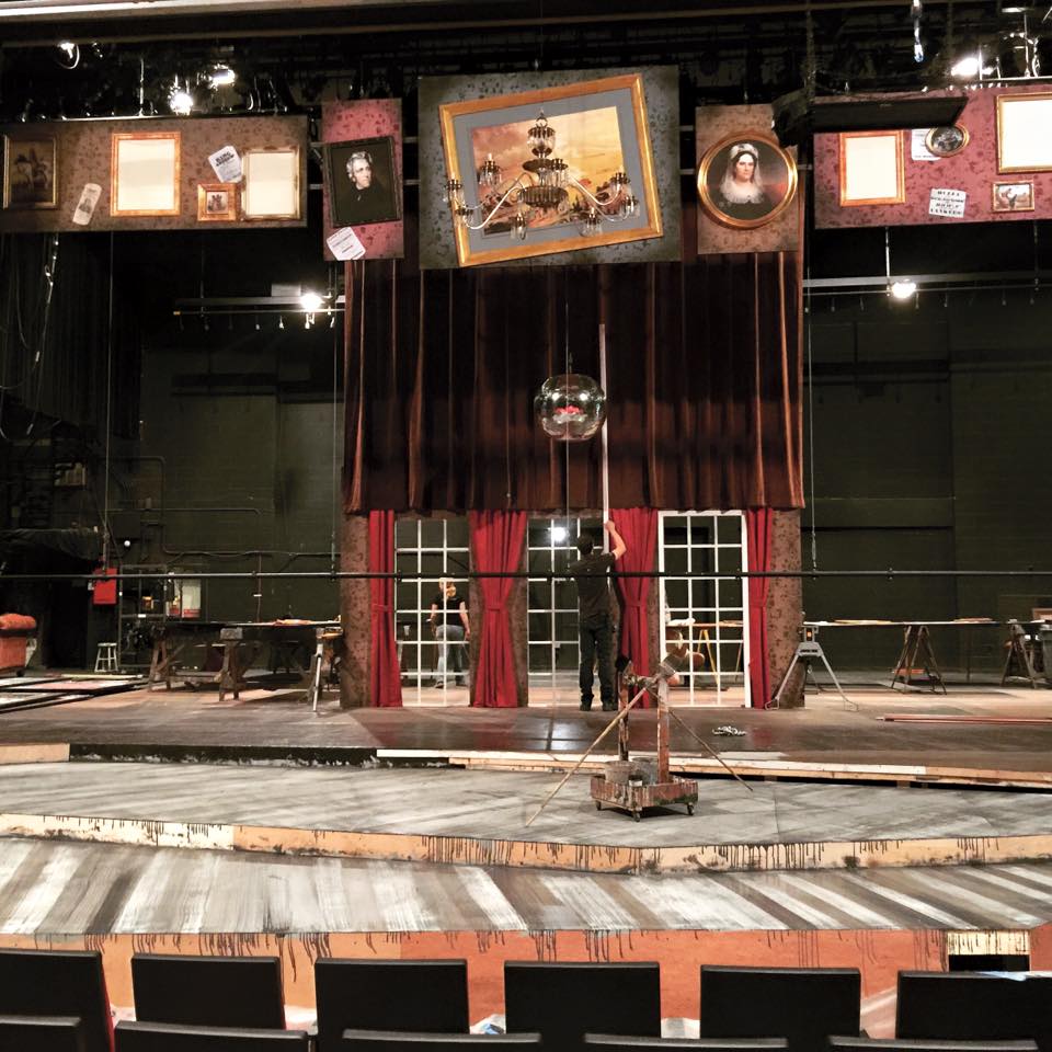 People working on a set on stage