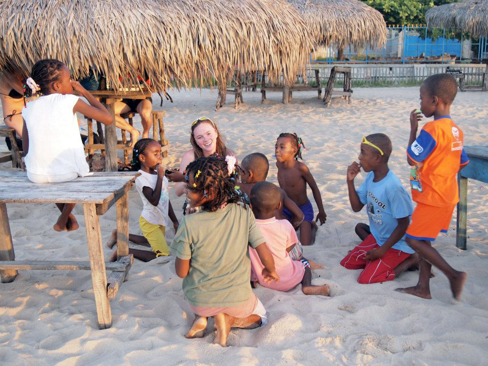 Caroline McInerney plays with children on a beach