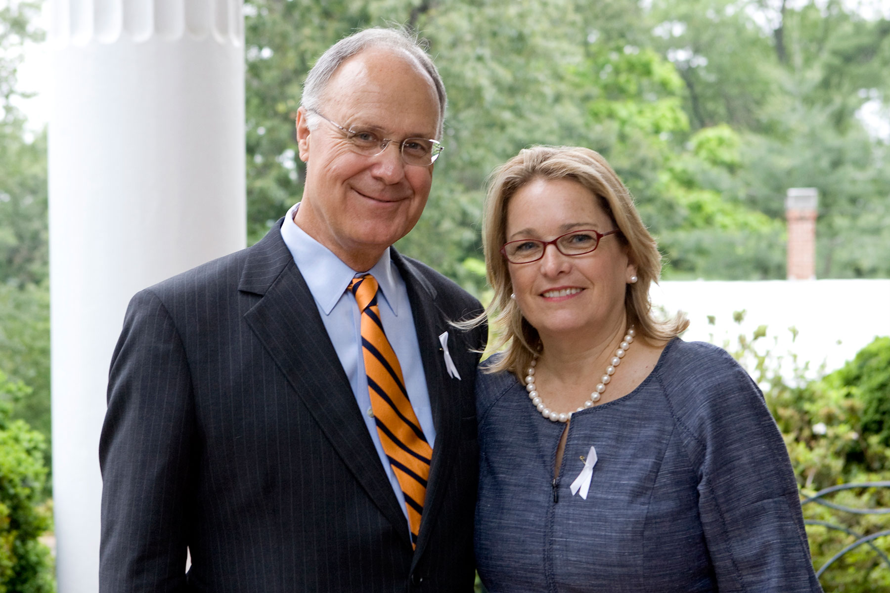 John T. Casteen III and Betsy Casteen stand next to each other smiling at the camera