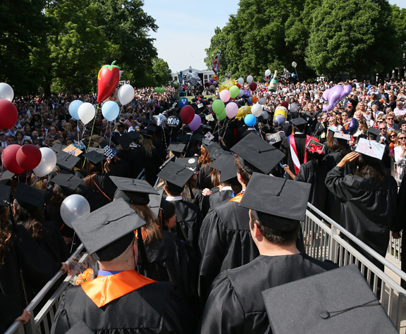Graduates walking onto the lawn