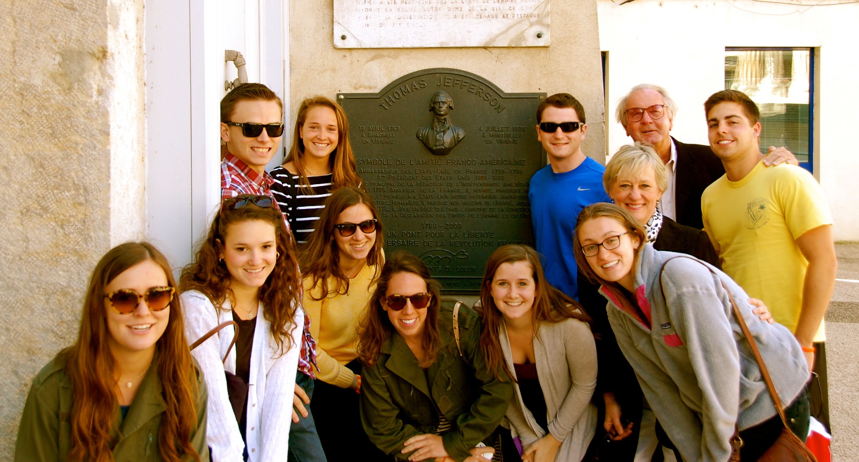 Group photo in front of a plaque dedicated to Thomas Jefferson