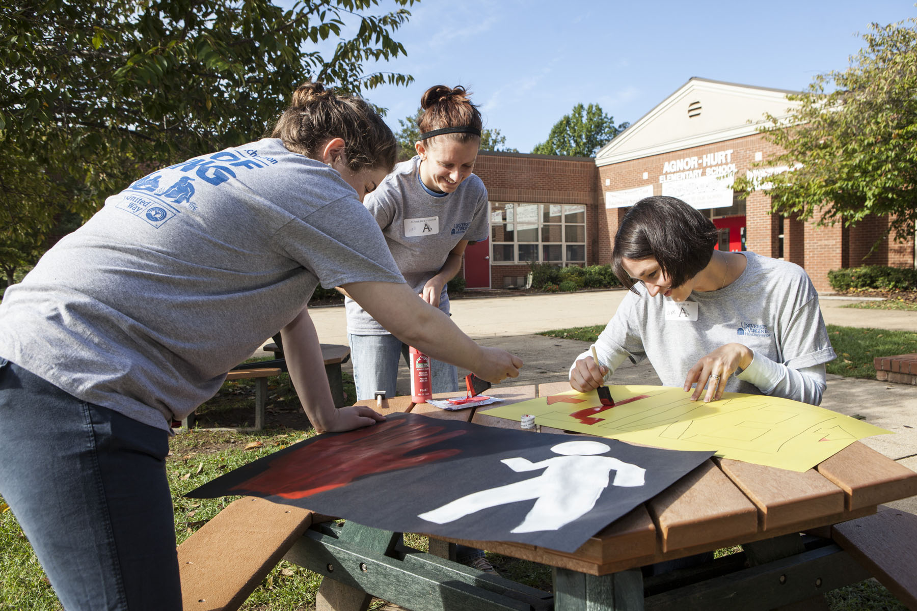 UVA Employees paint signs for Day of Caring