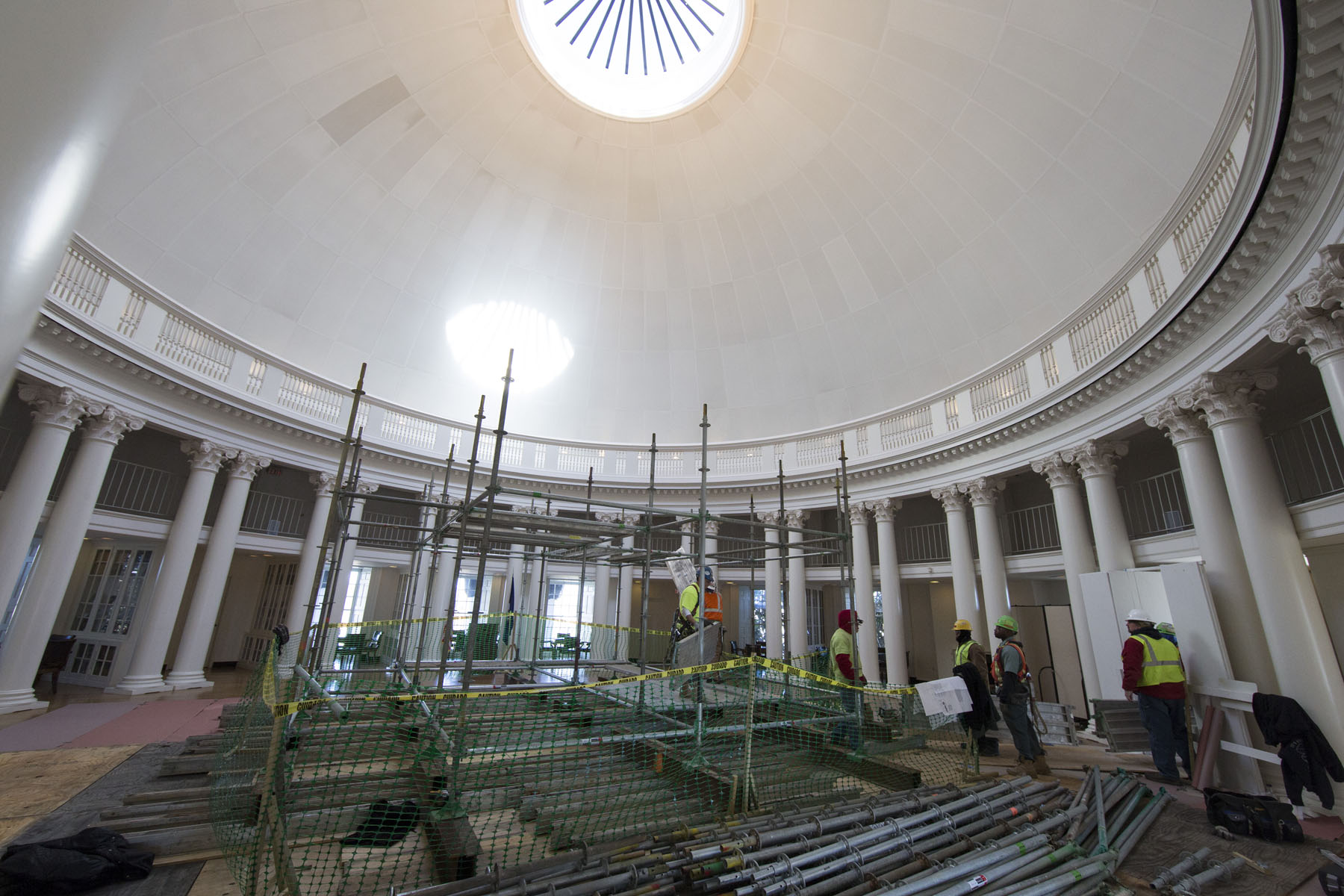 Scaffolding inside of the Rotunda Dome room surrounded by construction workers