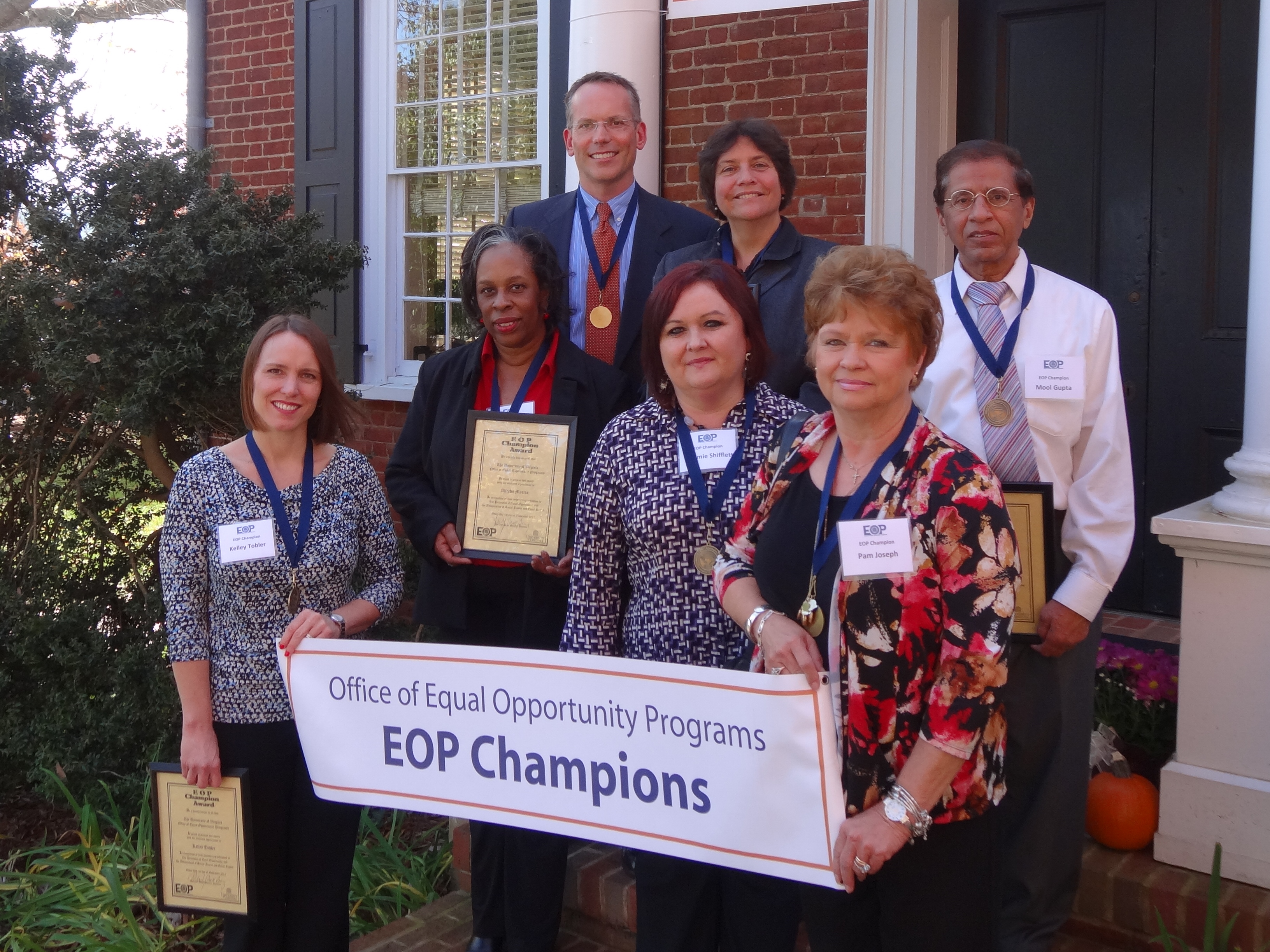 Group photo with a sign that says Office of Equal opportunity programs. EOP Champions