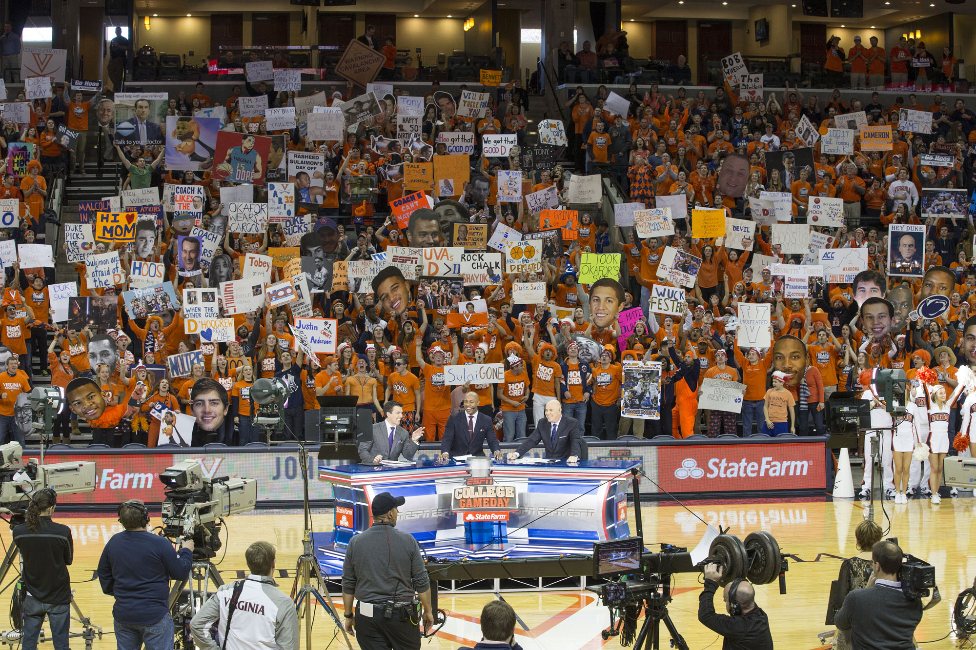 ESPN Game Day setup on the basketball court filming while UVA fans cheer behind them