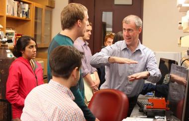Brian Helmke talking to students in a lab