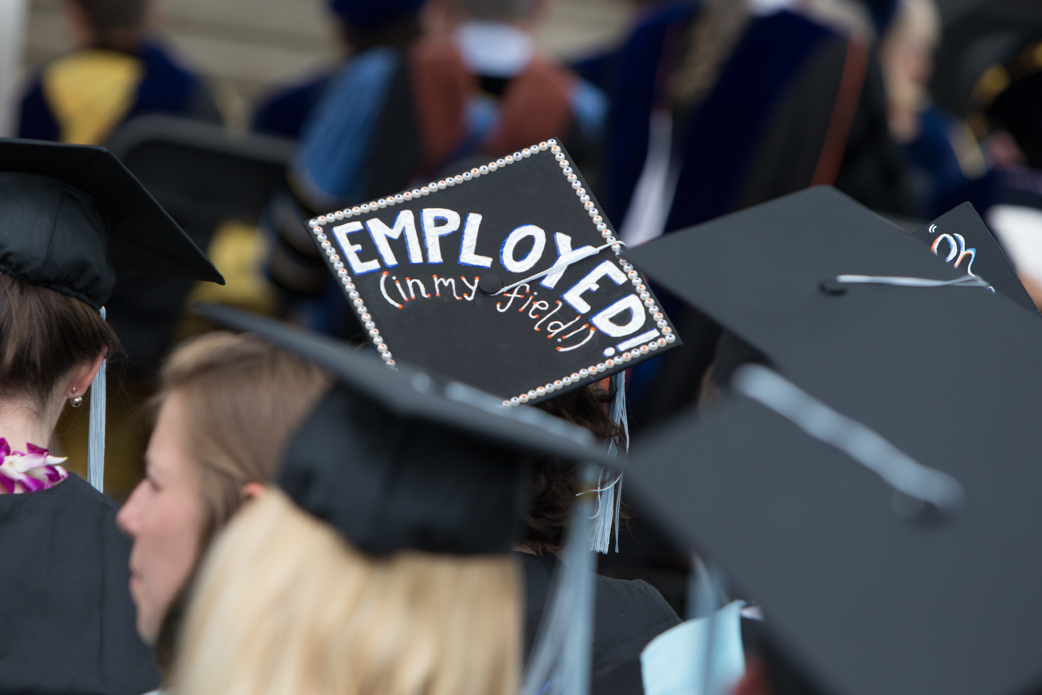Graduation cap reads: Employed!  (In my field!)