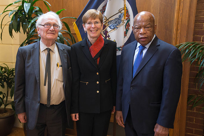Herman Hertzberger, the Hon. Joan E. Donoghue and U.S. Rep. John Lewis stand together for a picture