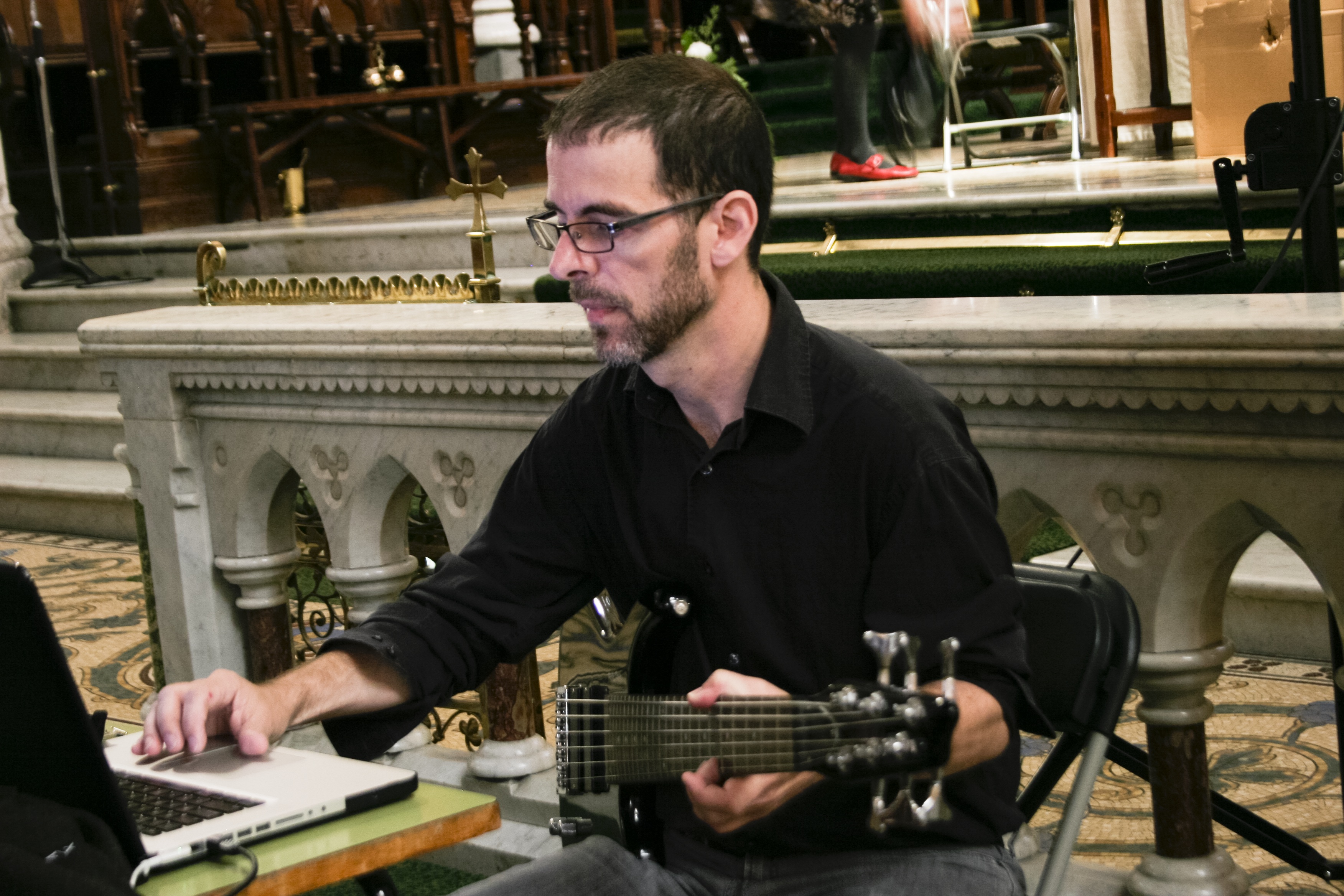 Stephen Vitiello playing a guitar that is connected to a computer