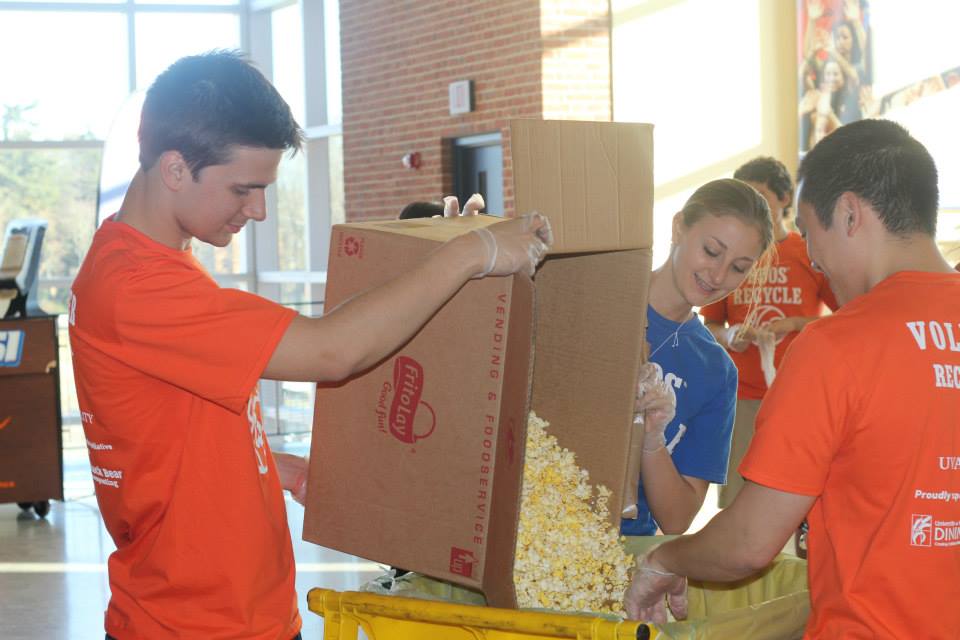 Dan Costello, Erica Stratton and Matt Kang fill up a push cart with butter popcorn