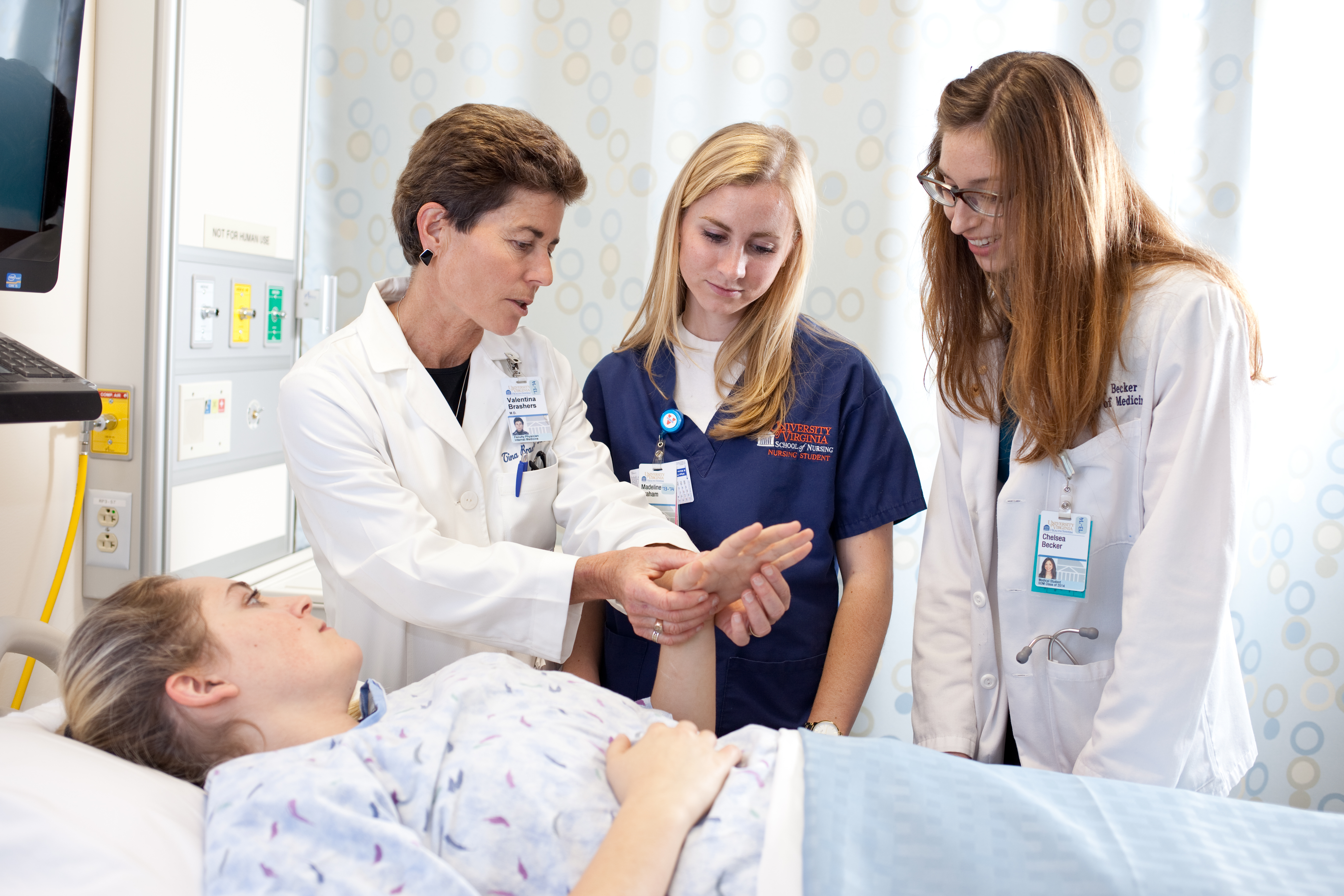 Dr. Tina Brashers talks to nursing students with a patient