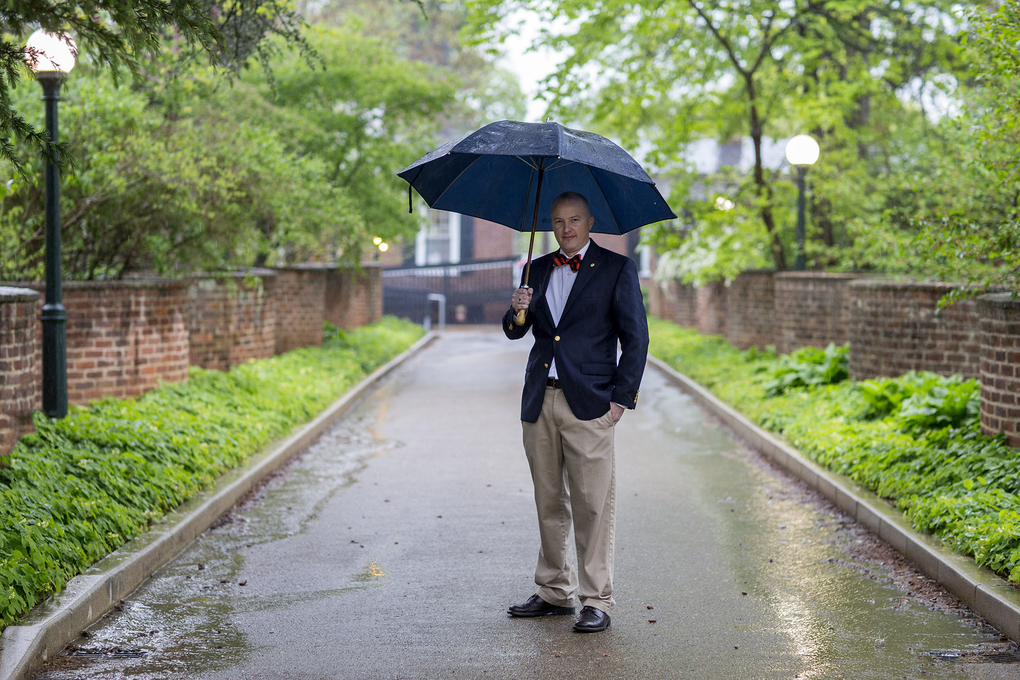 Jason Woodle holding an umbrella in the rain