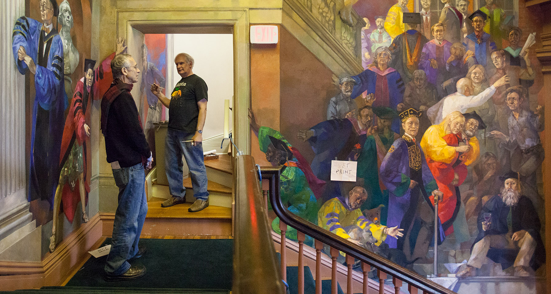 Artist painting a mural in Old Cabell Hall