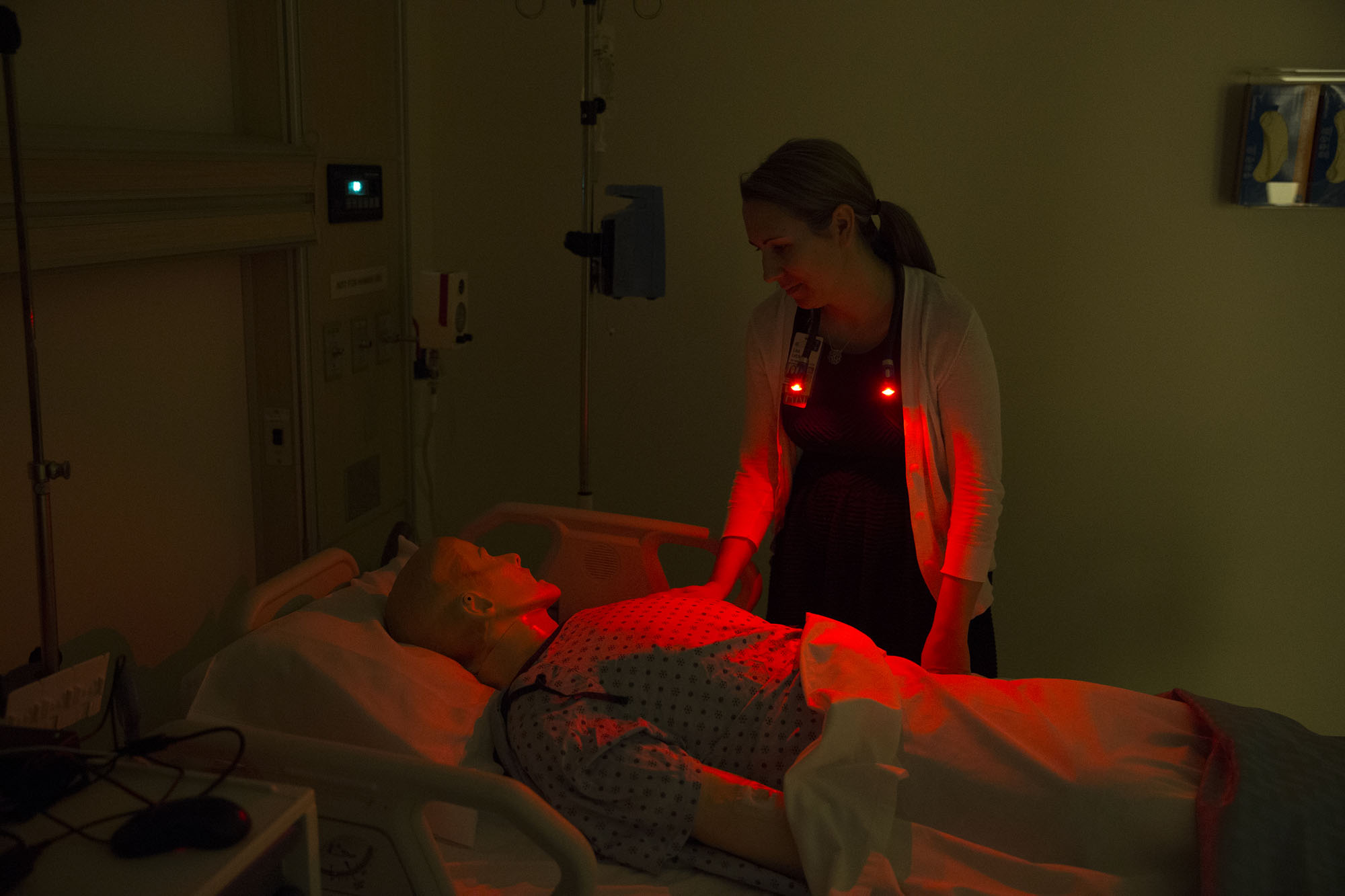 Lisa Letzkus, works with a dummy patient in a darkened room