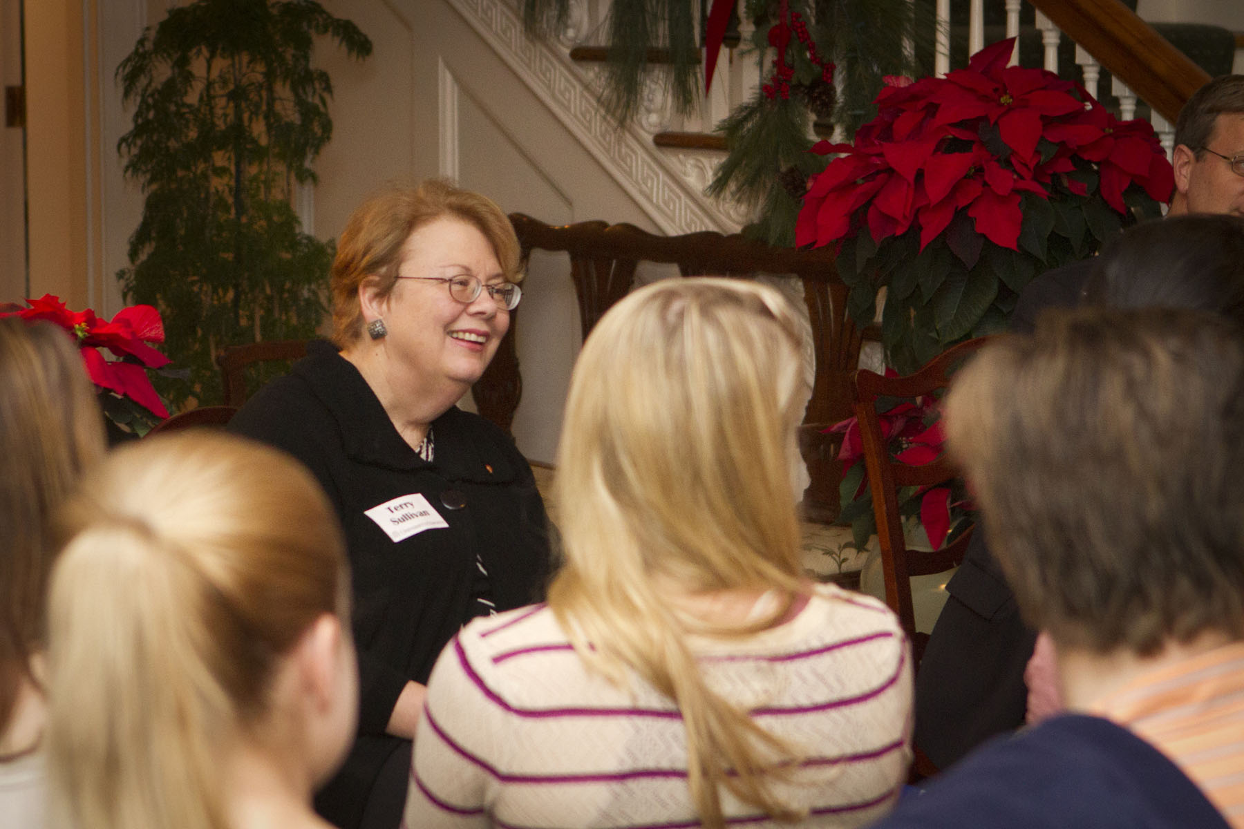 President Teresa A. Sullivan talking to a group of people