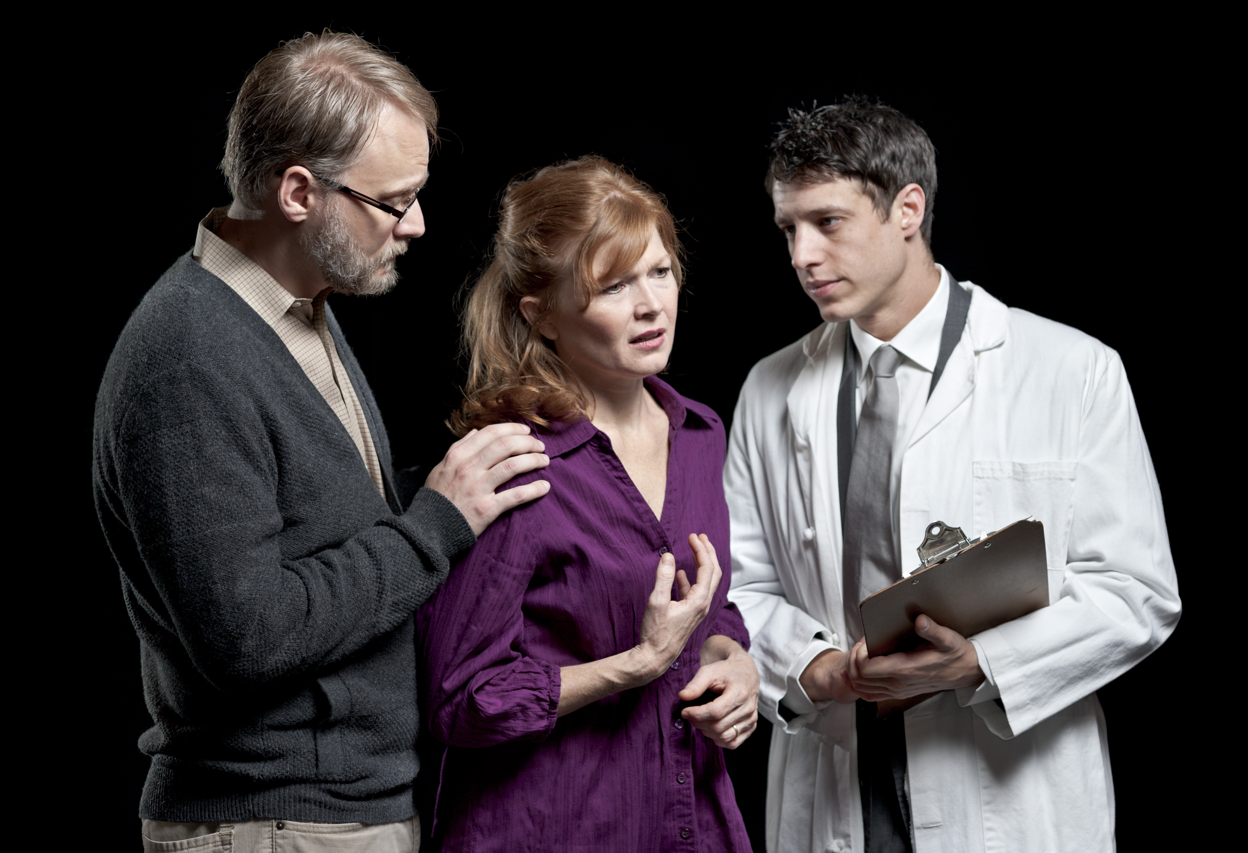Diana (Catherine Ogden), her husband Dan (Ross Wheeler Left), and Dr. Fine (Jonathan Coarsey, right) stand together on stage