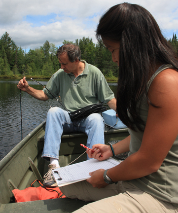Michael Pace and Carol Yang on a boat conducting a water study