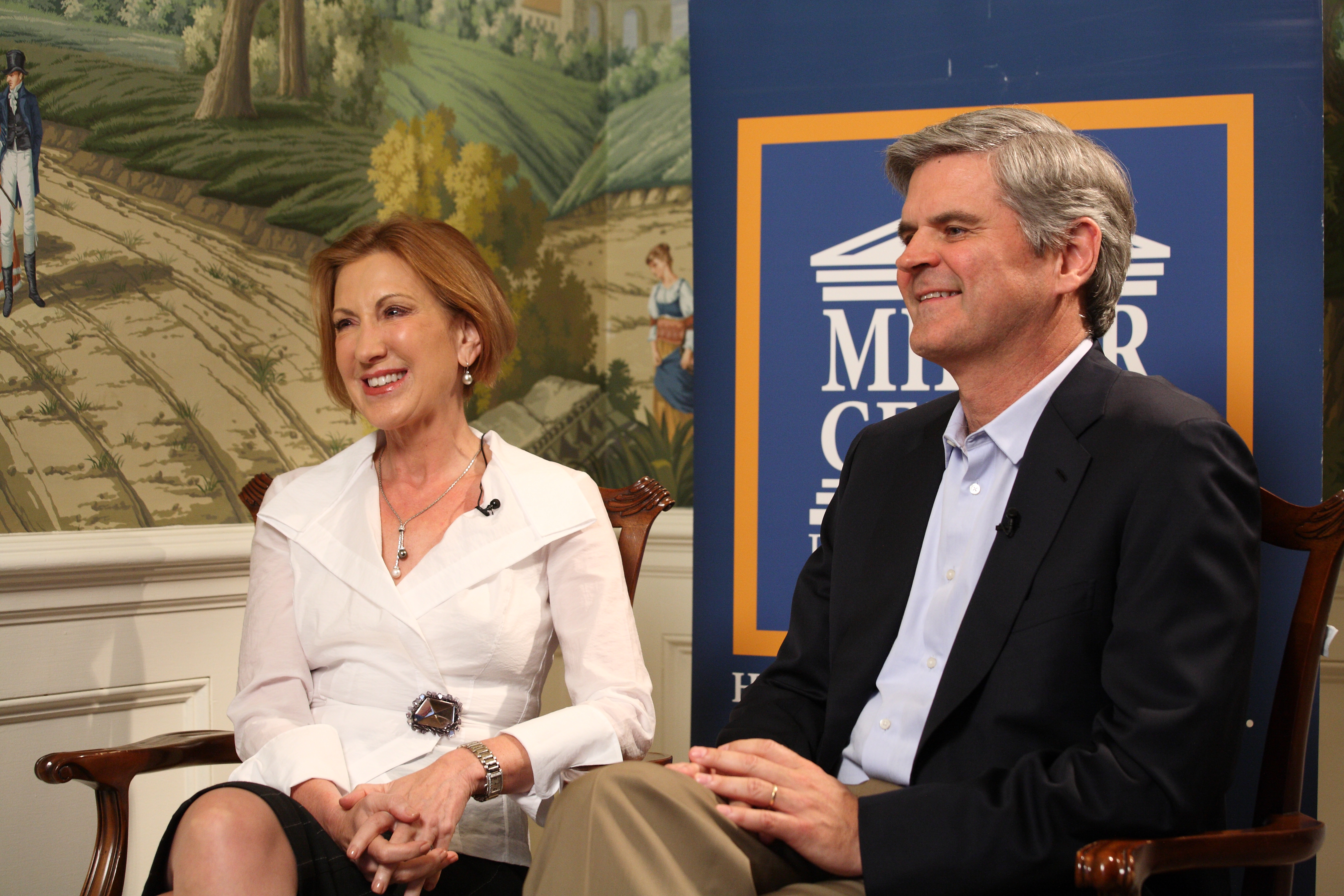 Carly Fiorina and Steve Case sit in chairs for an interview