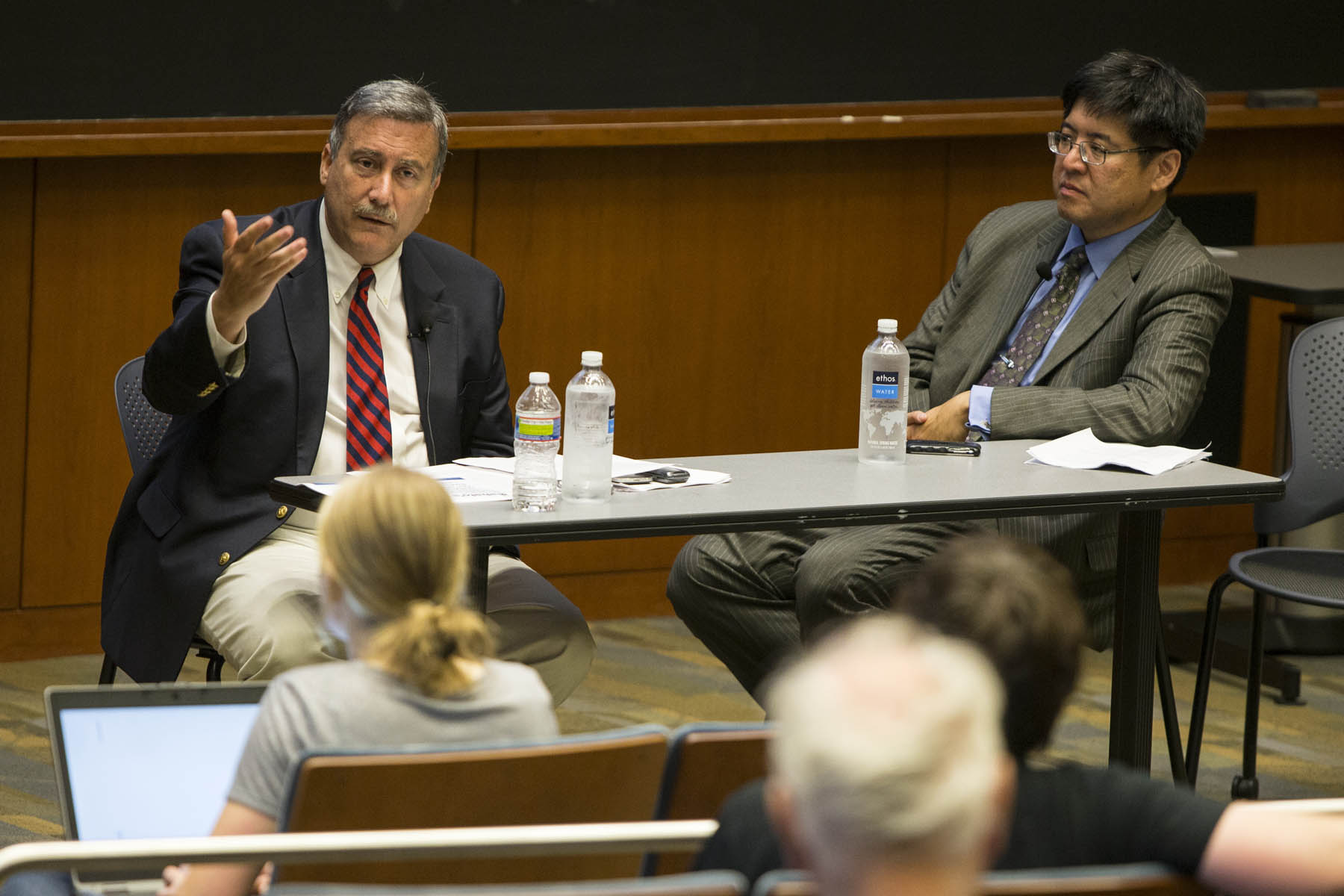  Larry Sabato, left, and Sam Wang, right, talk to a crowd
