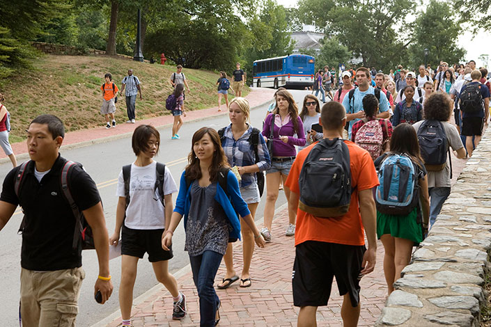 Students walking on a sidewalk to and from classes