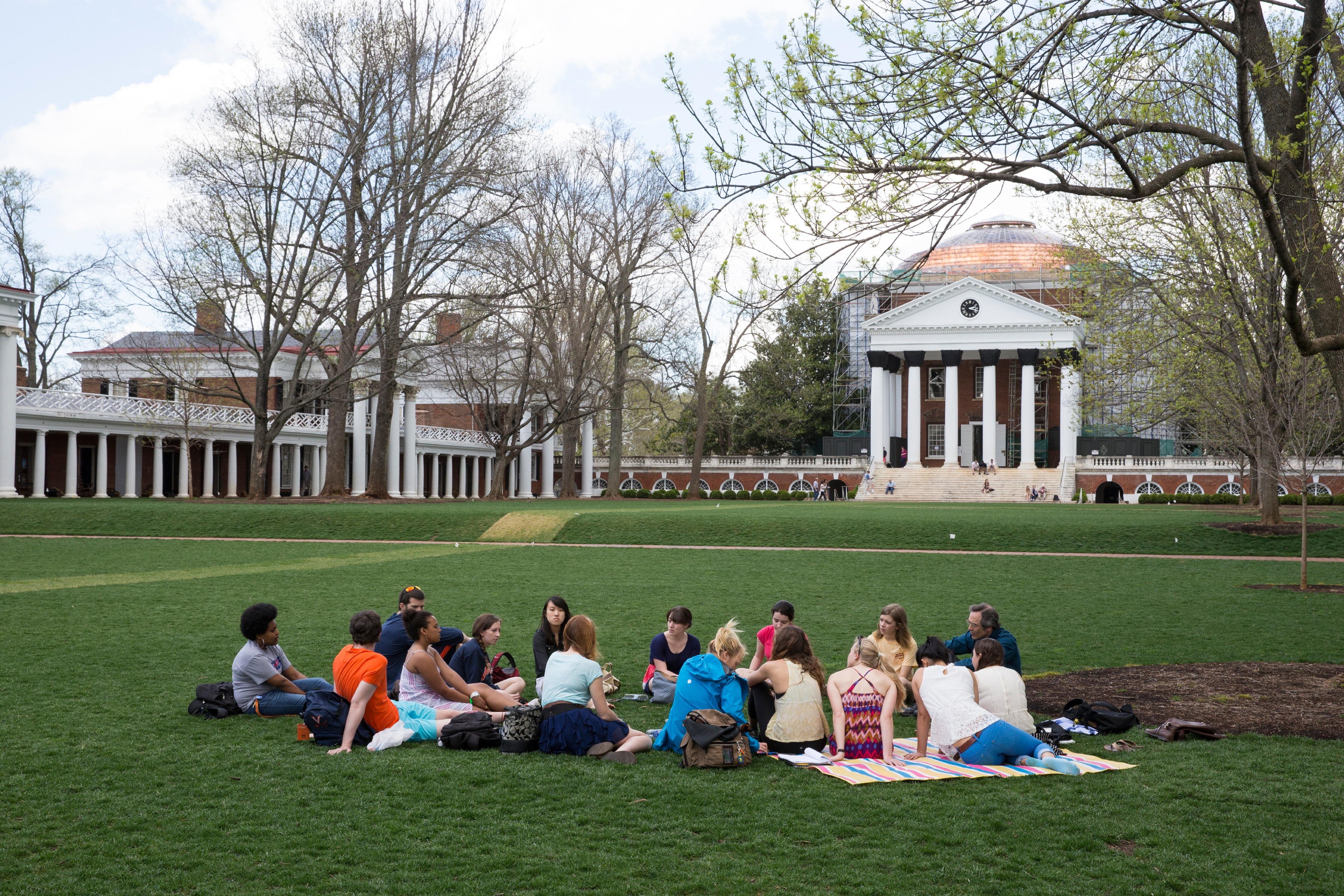 Students sit in a circle on the Lawn