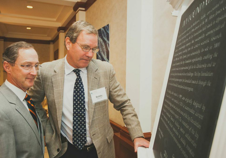 Dr. Richard P. Shannon, left, and Dr. Robert W. Battle, right, read a plaque