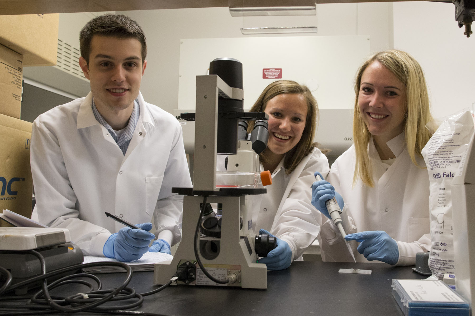 Tyler Brobst, Jessica Ungerleider and Alyssa Long stand together in the lab