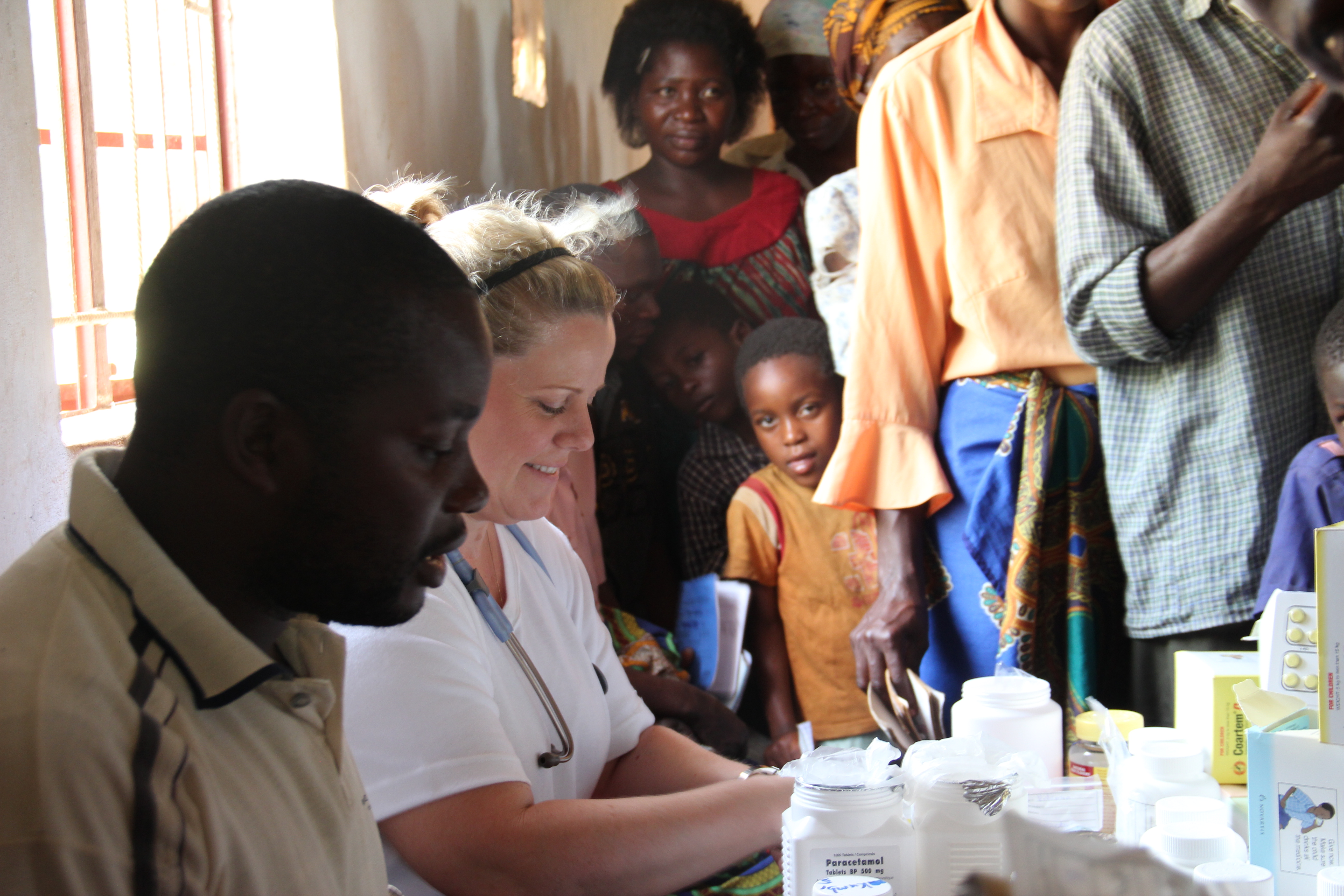 Vicki Jenkins working with Malawi citizens at a nurses station
