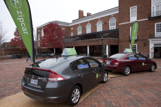 Zipcars parked on the sidewalk