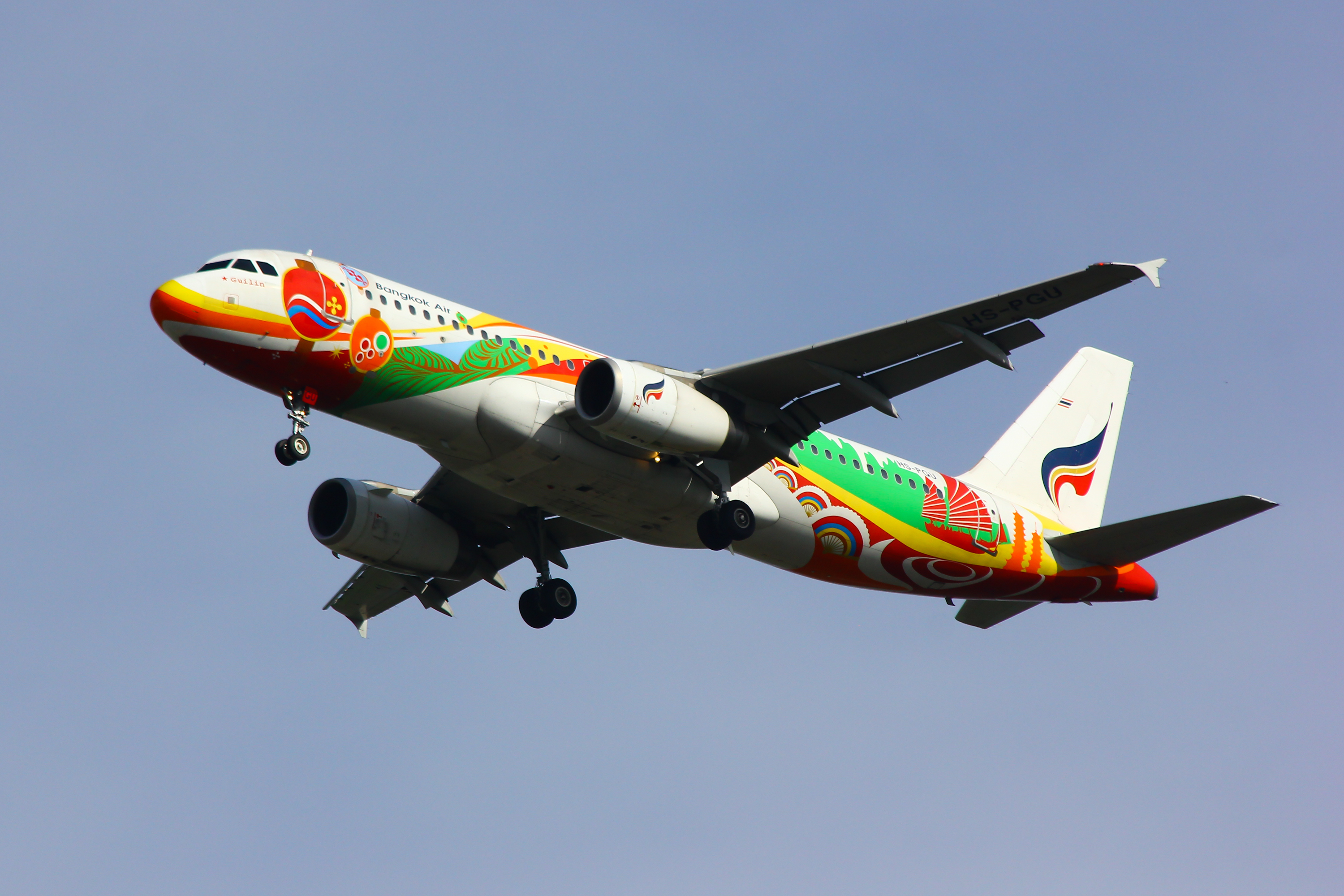 Bangkok Air airplane flying with bright artwork painted on the plane