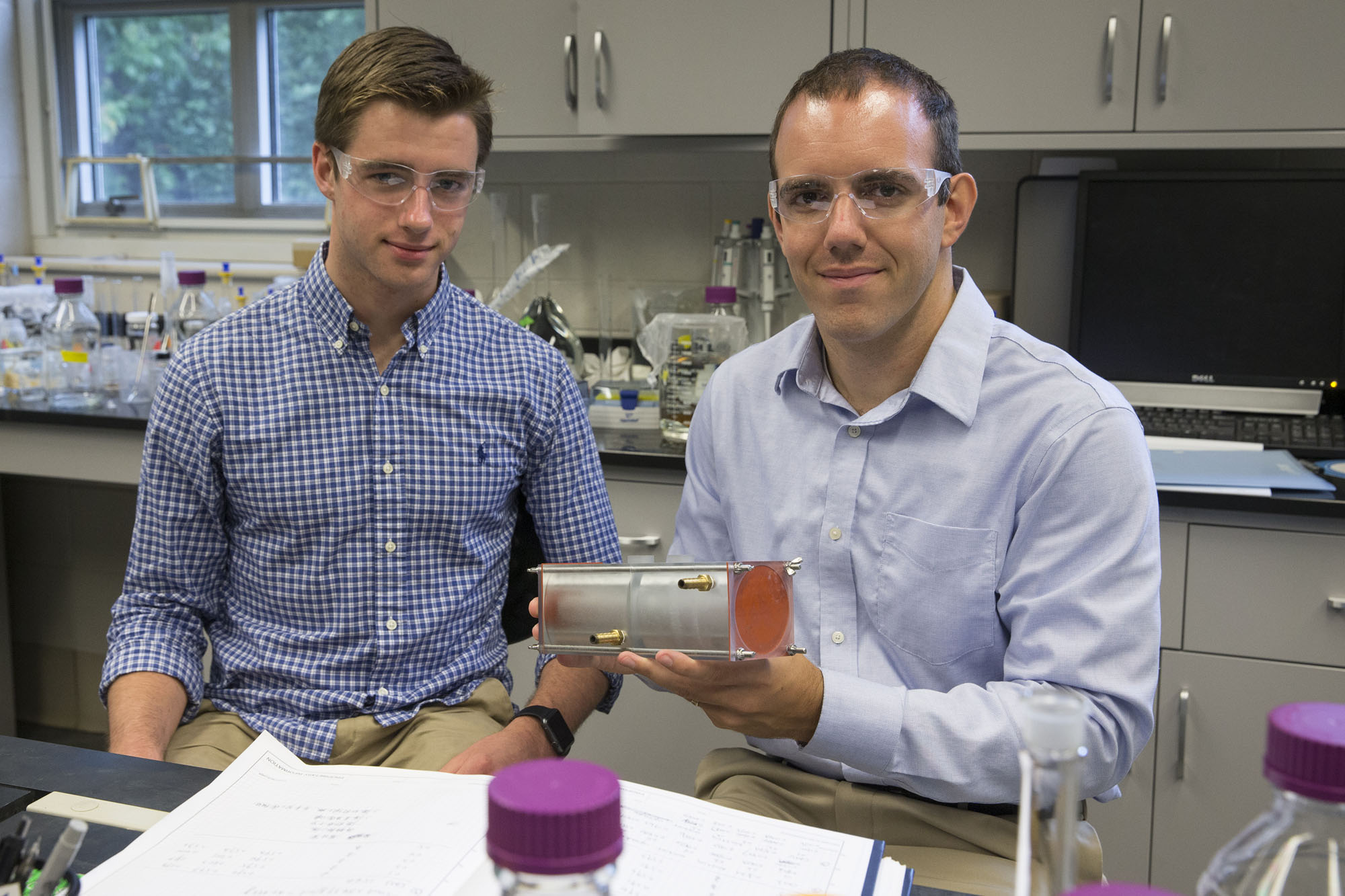 Andrew Biedermann (left), works on polymer membranes with Geoffrey Geise, in a lab