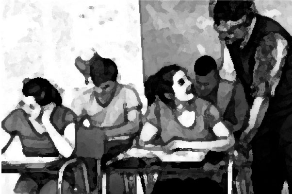 abstract blurry image of students at desks and a teacher helping a student