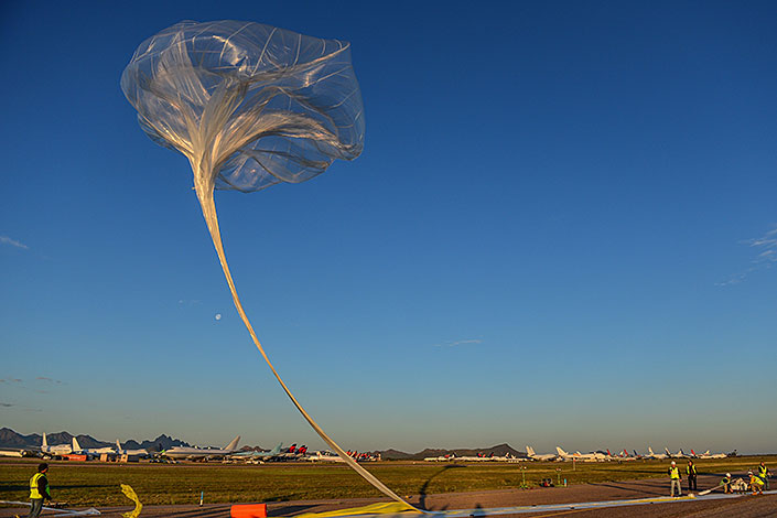 Big clear plastic Balloon floating in the air above a tarmac