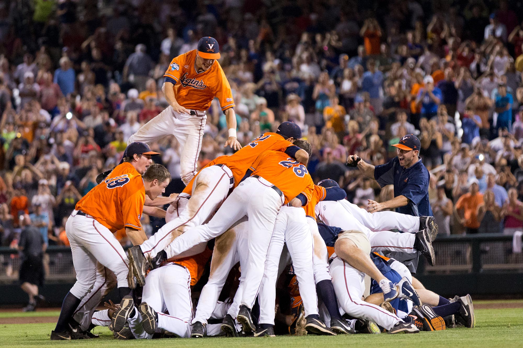 UVA baseball team create a pile on on the field after victory