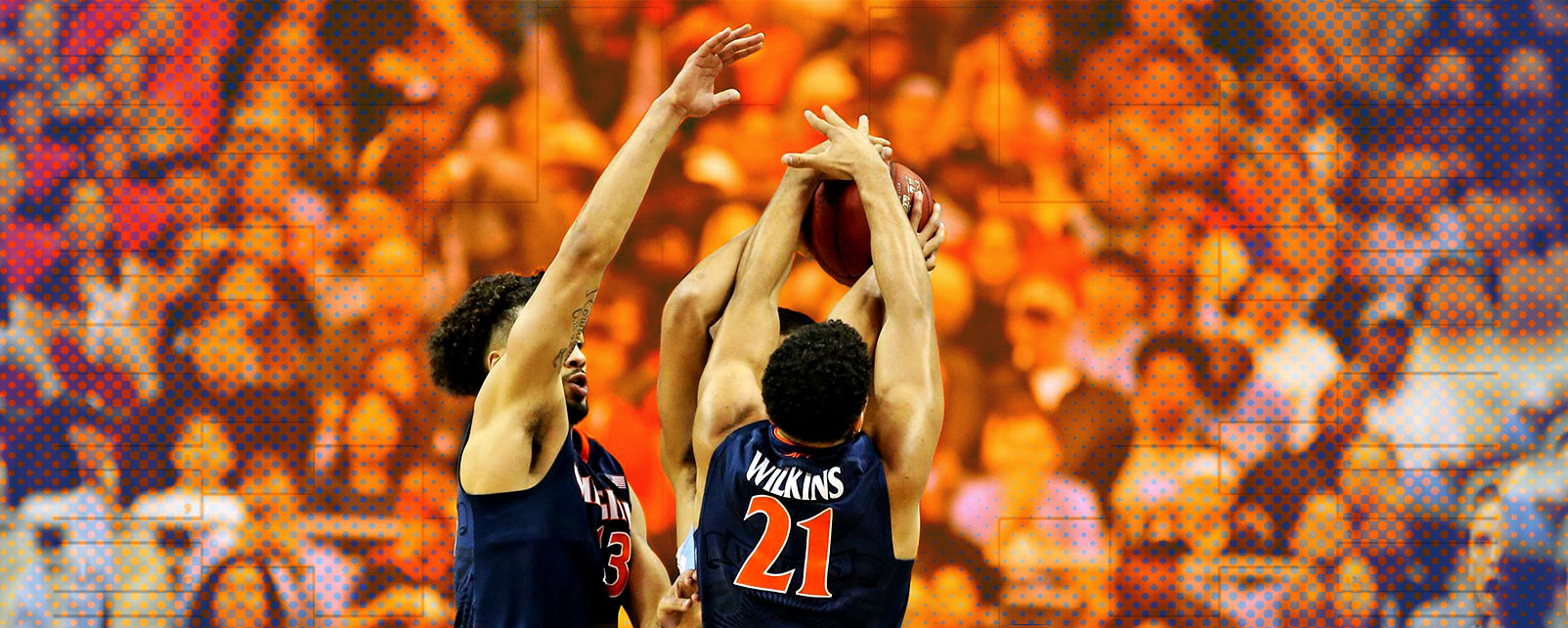 Basketball players jumping to block an opponents shot